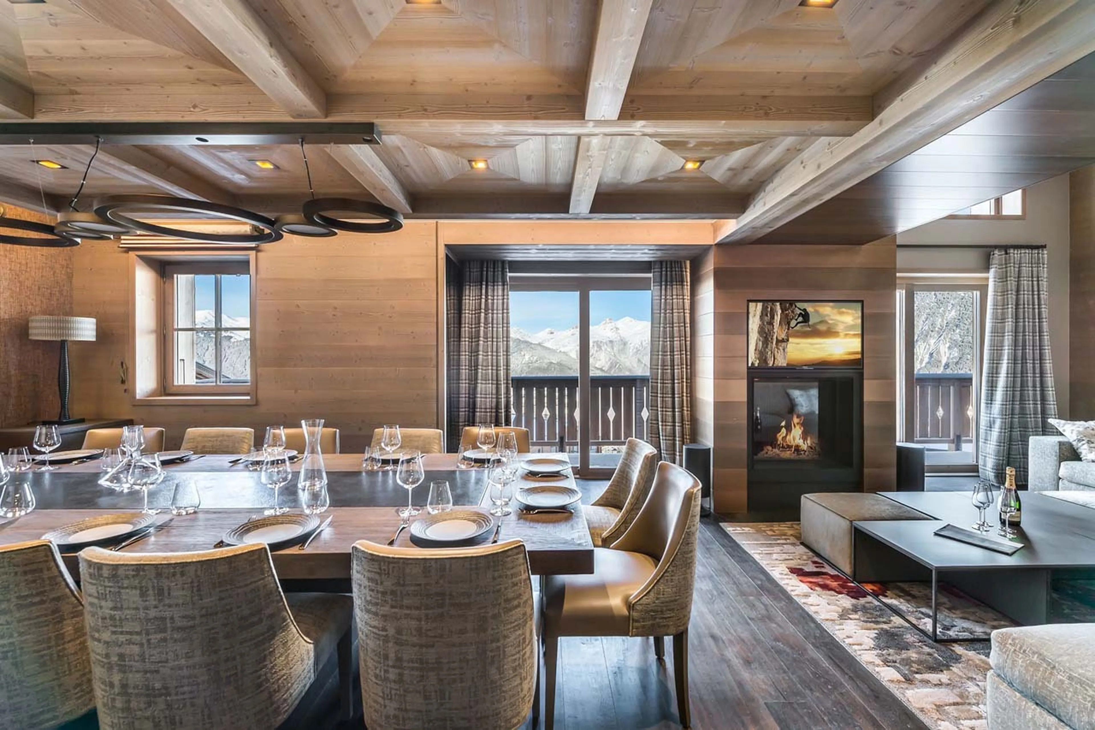 Dining table and fireplace at Chalet Elixir in Courchevel 1850