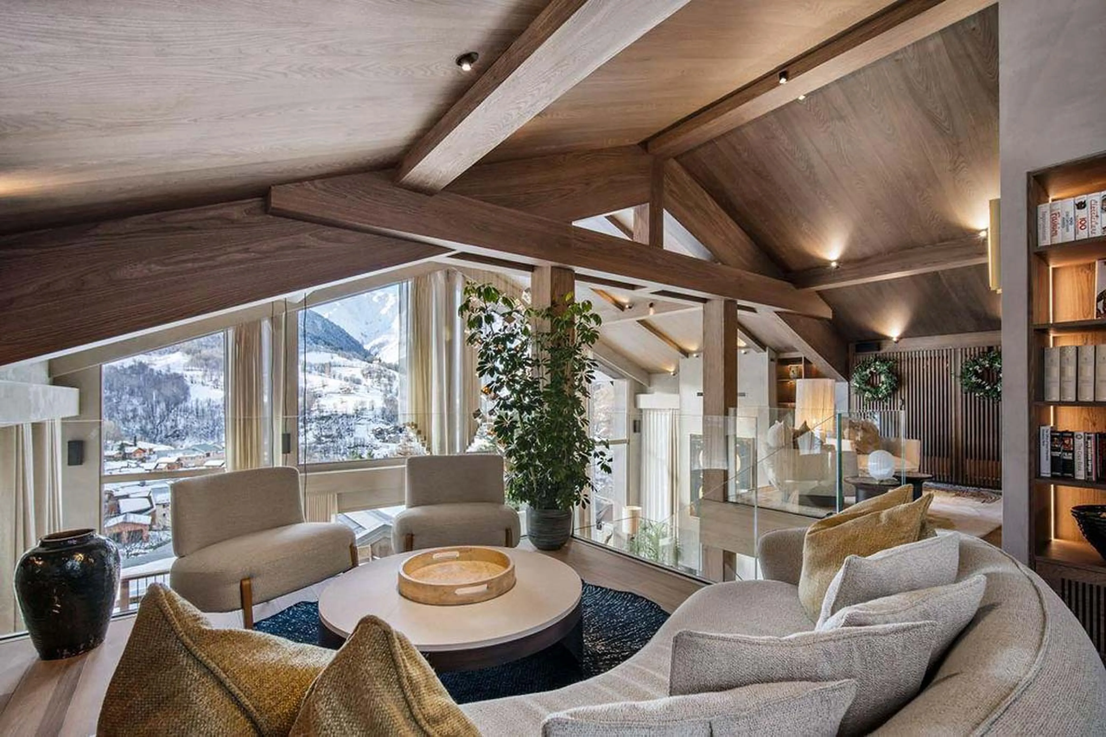 Sofa and armchairs arranged around coffee table in Chalet Escapade, St Martin de Belleville