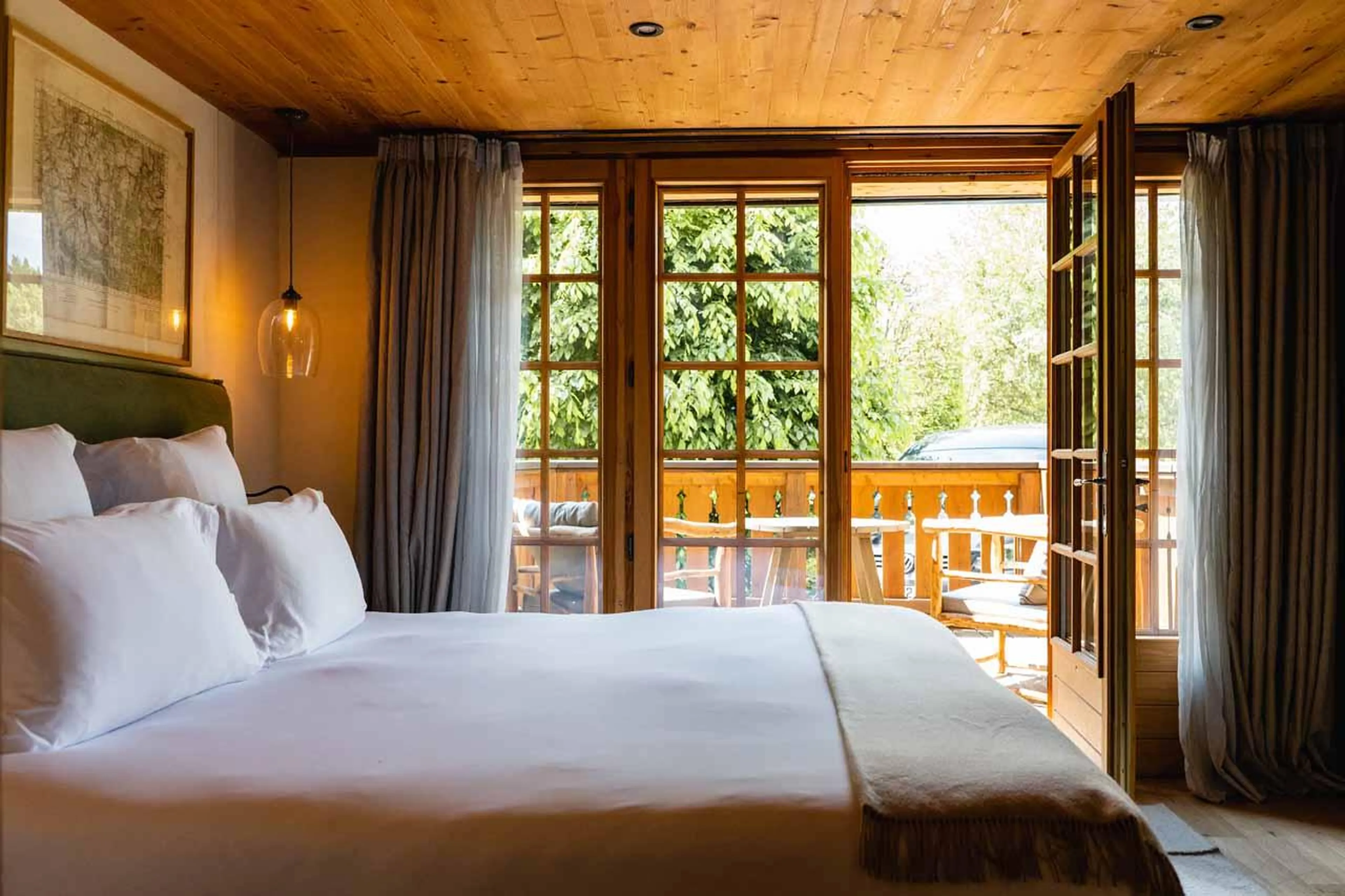Double bedroom with French doors leading to balcony in Chalet Eustache, Megeve