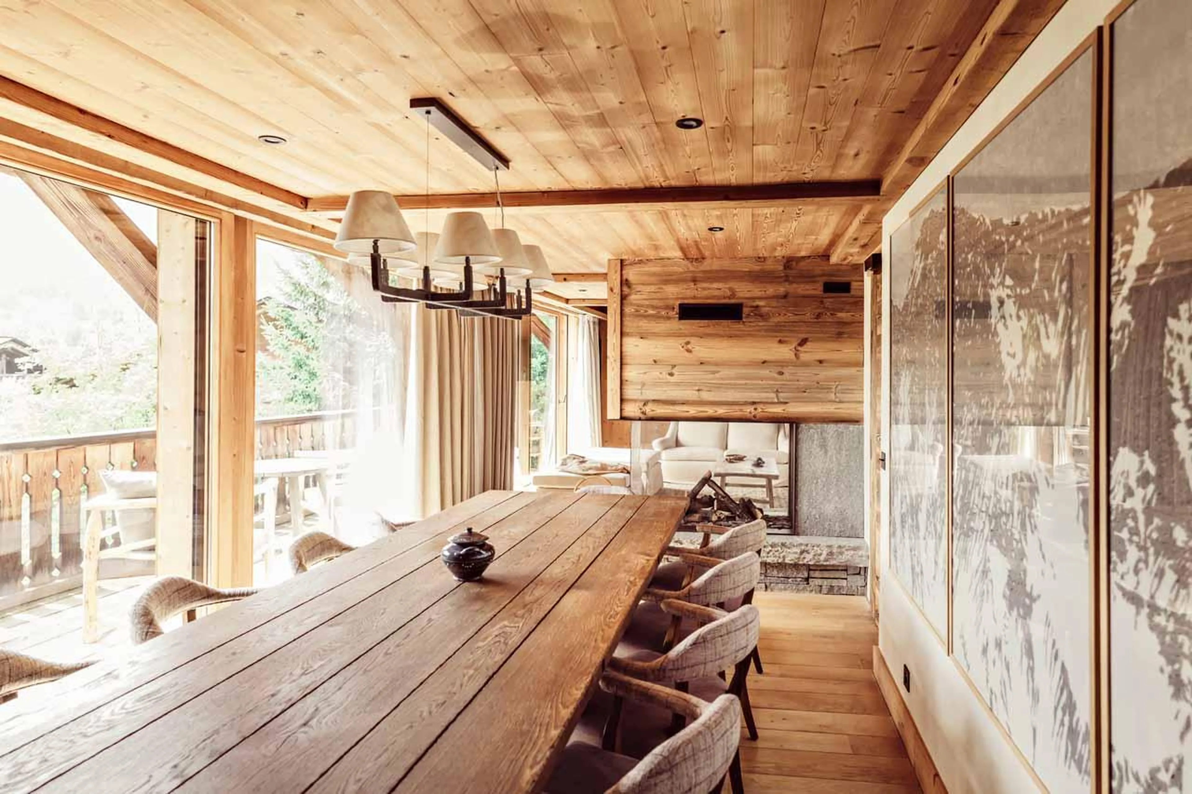 Dining table in front of glass doors in Chalet Eustache, Megeve