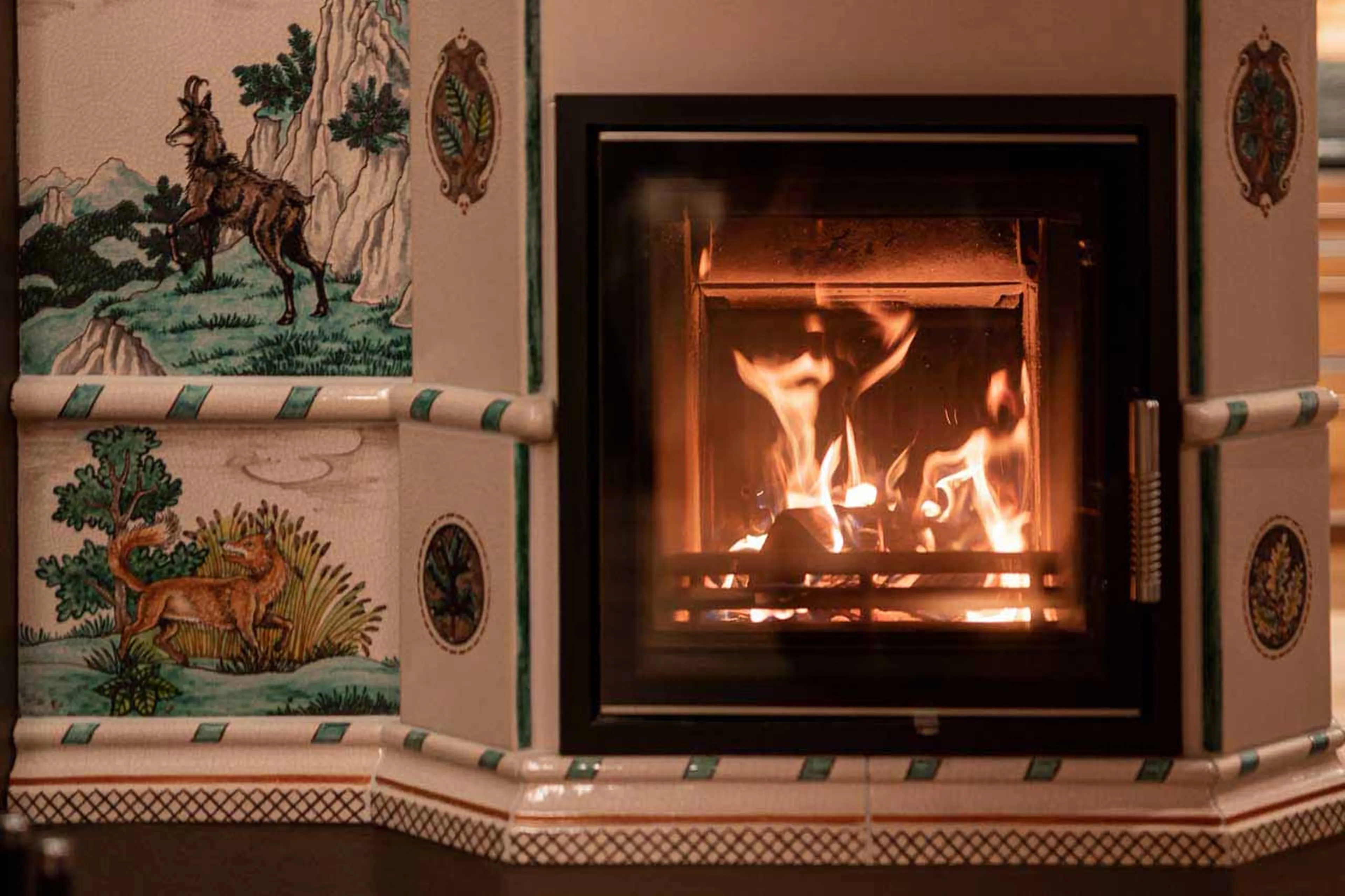 Fireplace in dining room at Chalet Falcon in Lech