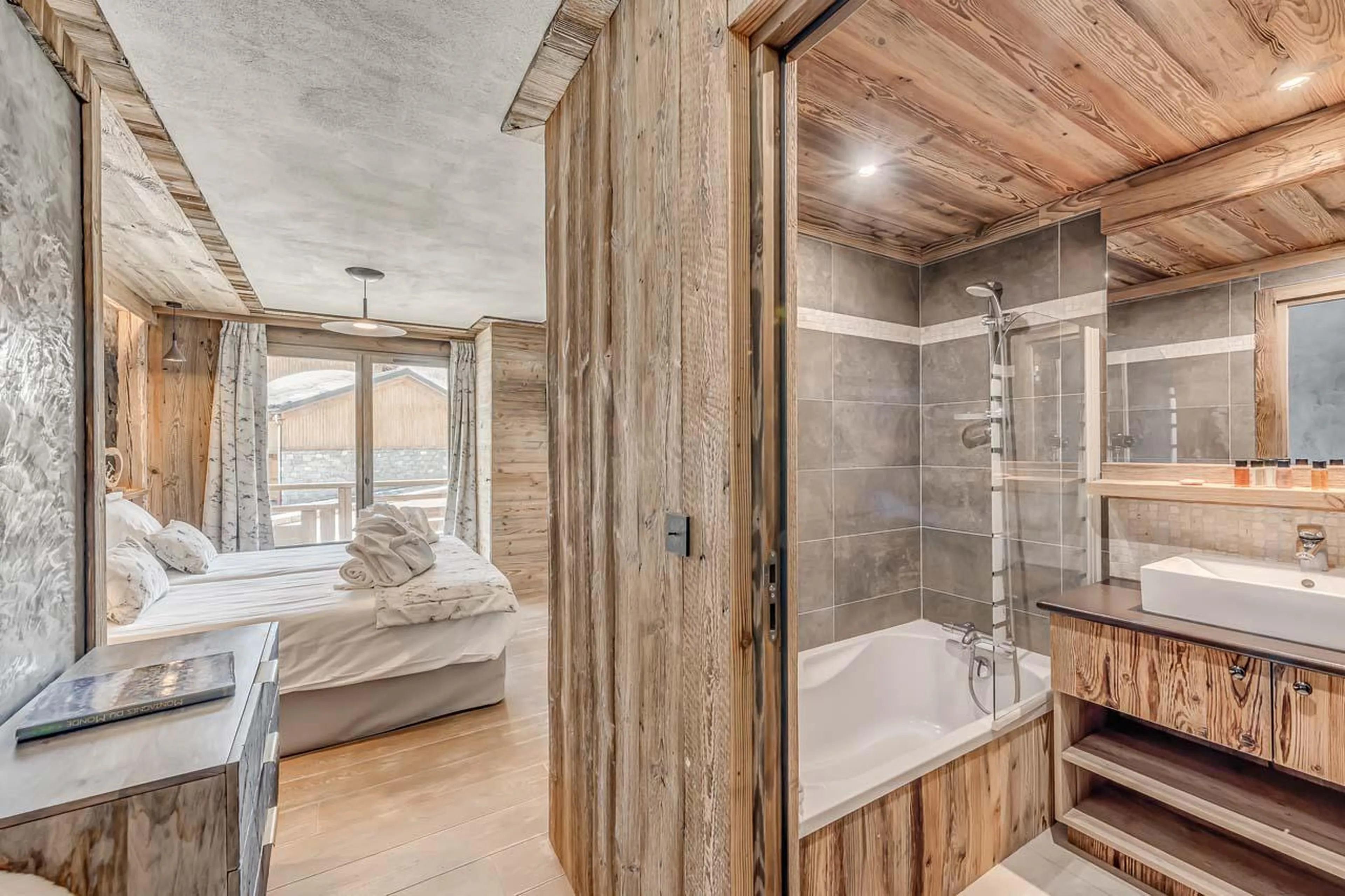 En suite bathroom with bathtub and heated towel rail at Chalet Ganga in Tignes
