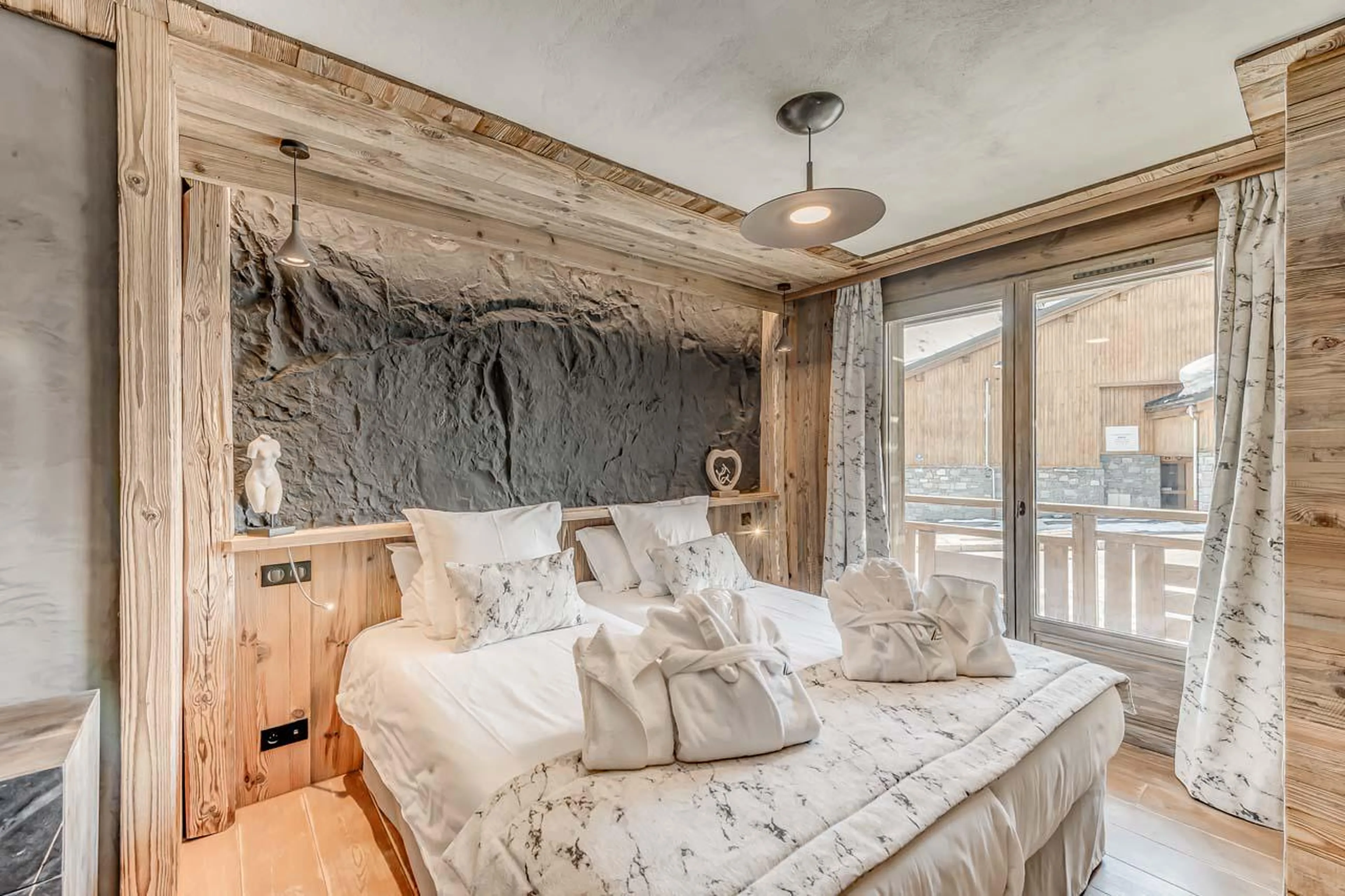 Pierre bedroom with access to south-facing balcony at Chalet Ganga in Tignes