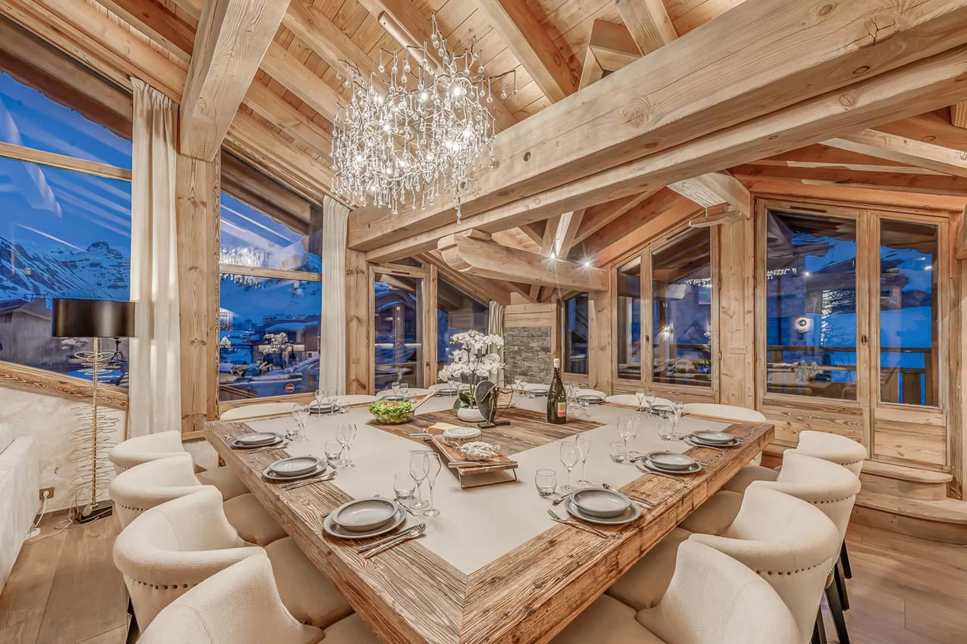 Dining table with elegant ornamental chandelier at Chalet Ganga in Tignes