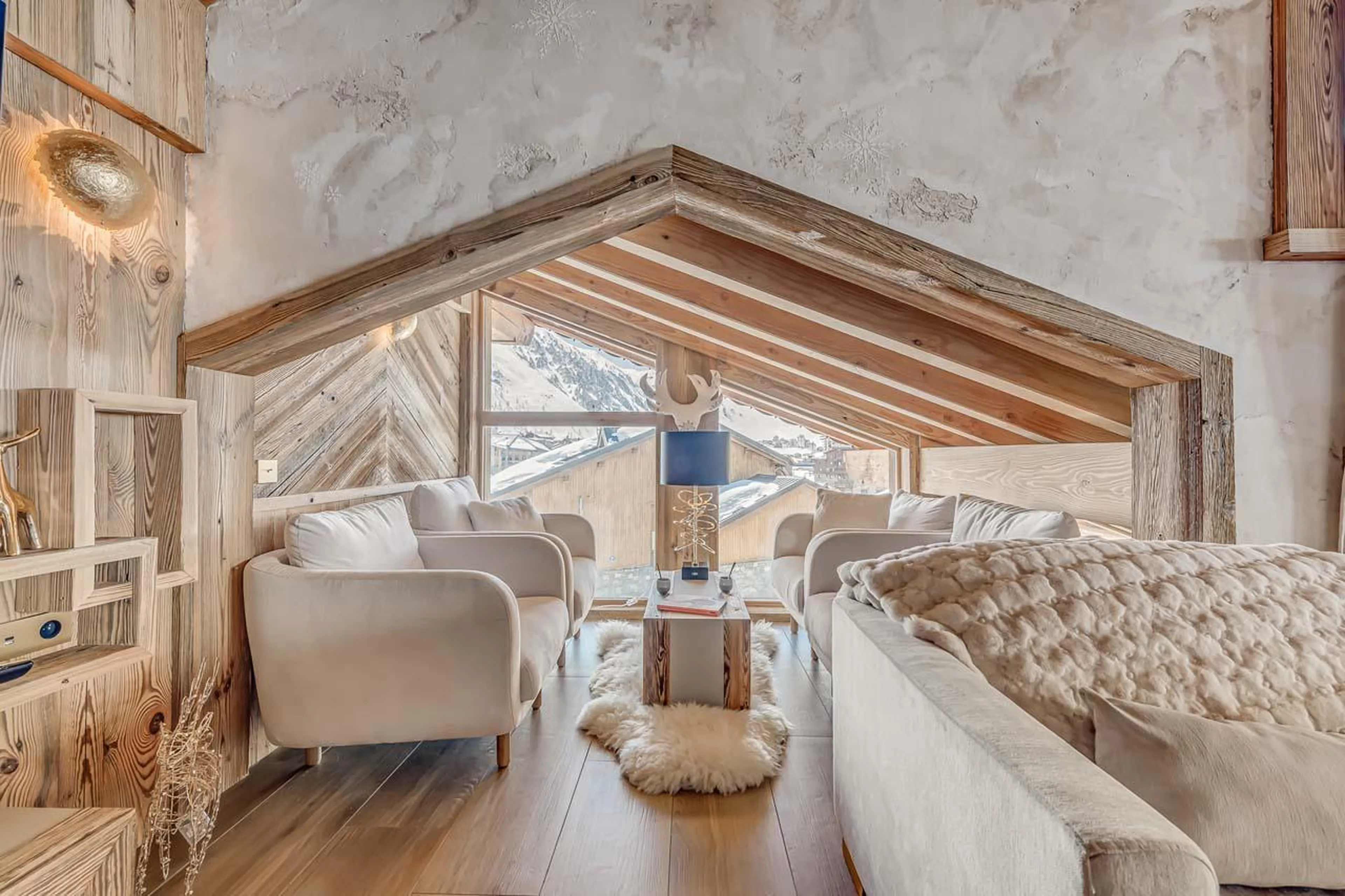 Cosy sofa area with impressive mountain views at Chalet Ganga in Tignes