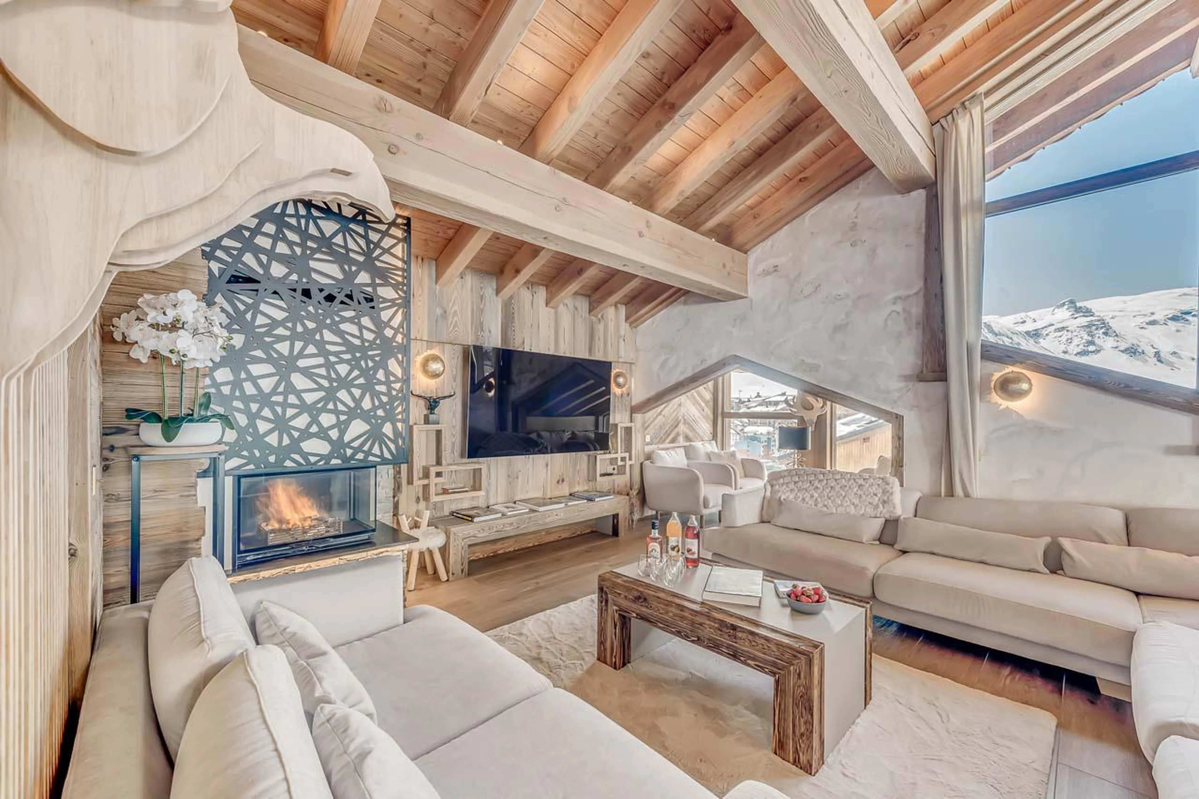 Living area with modern fireplace and mountain views at Chalet Ganga in Tignes