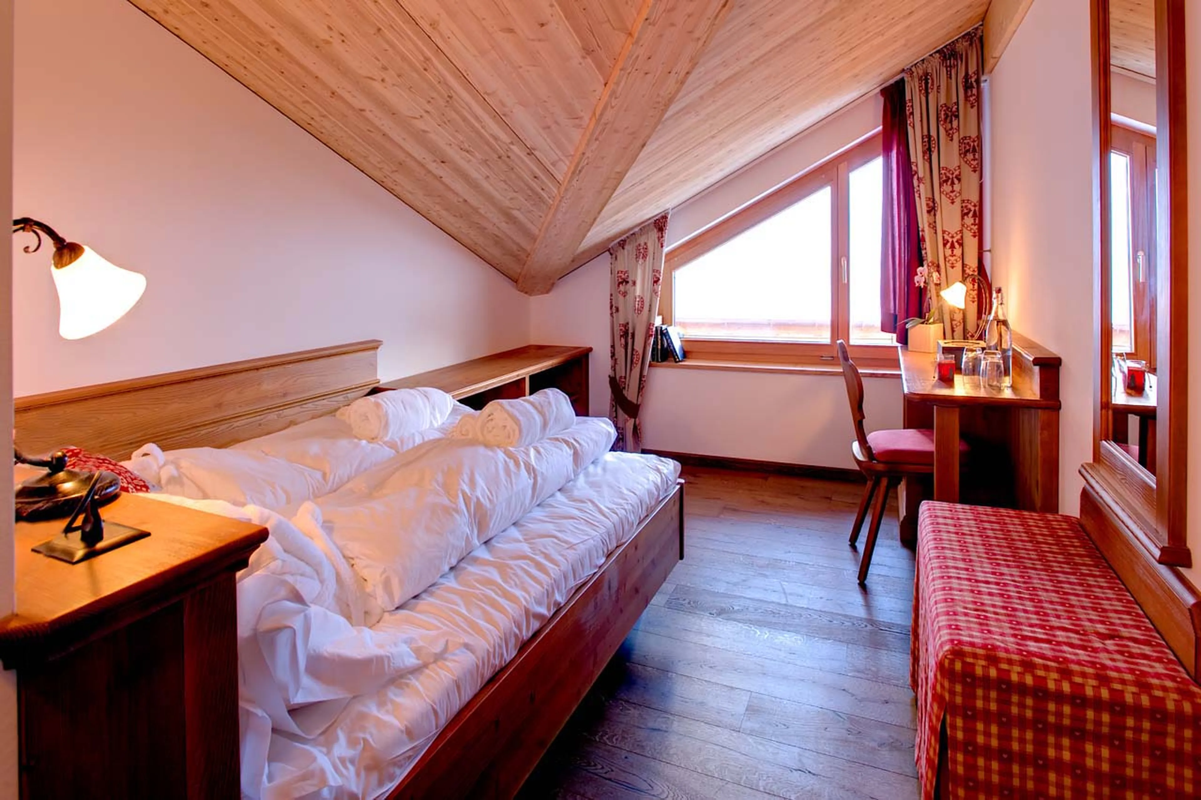 Queen-size bed in bedroom five at Chalet Gemini in Zermatt