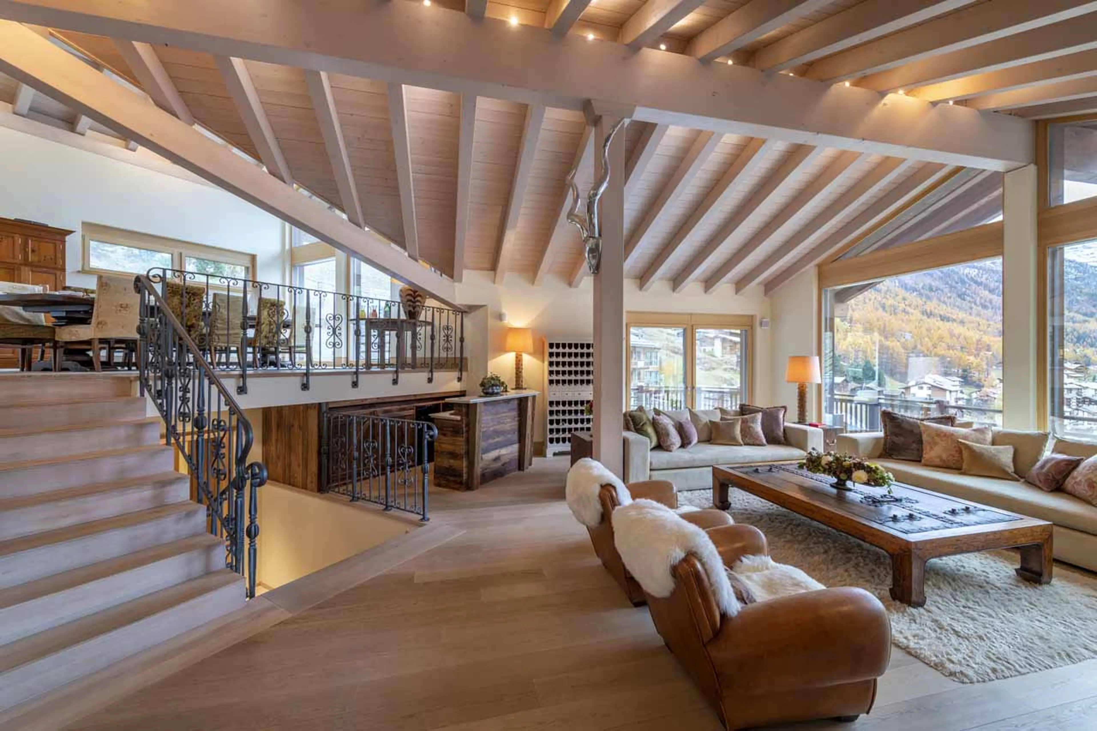 Open plan living area and elevated dining area at Chalet Grace in Zermatt