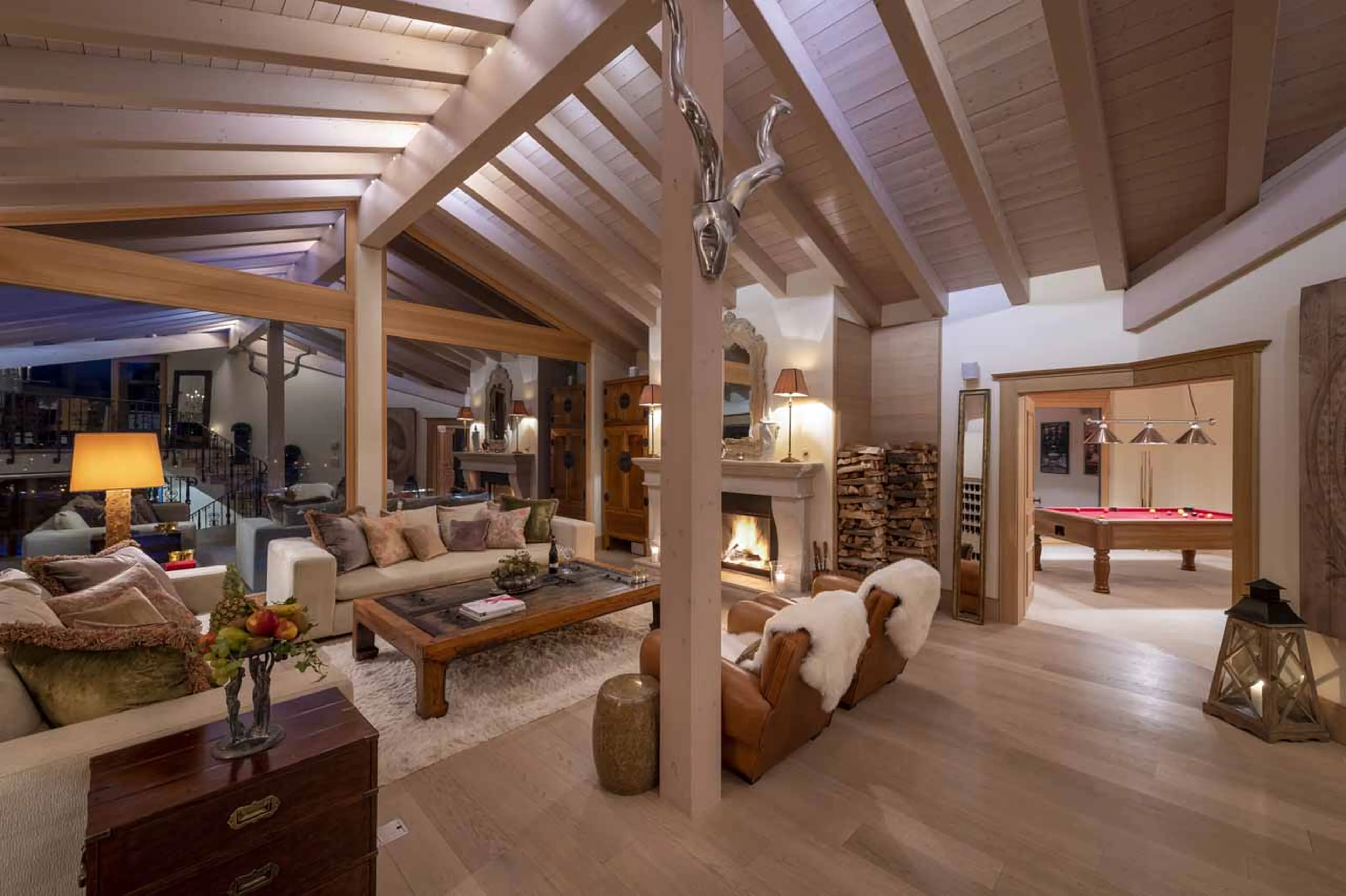 Living room and adjoining games room at Chalet Grace in Zermatt