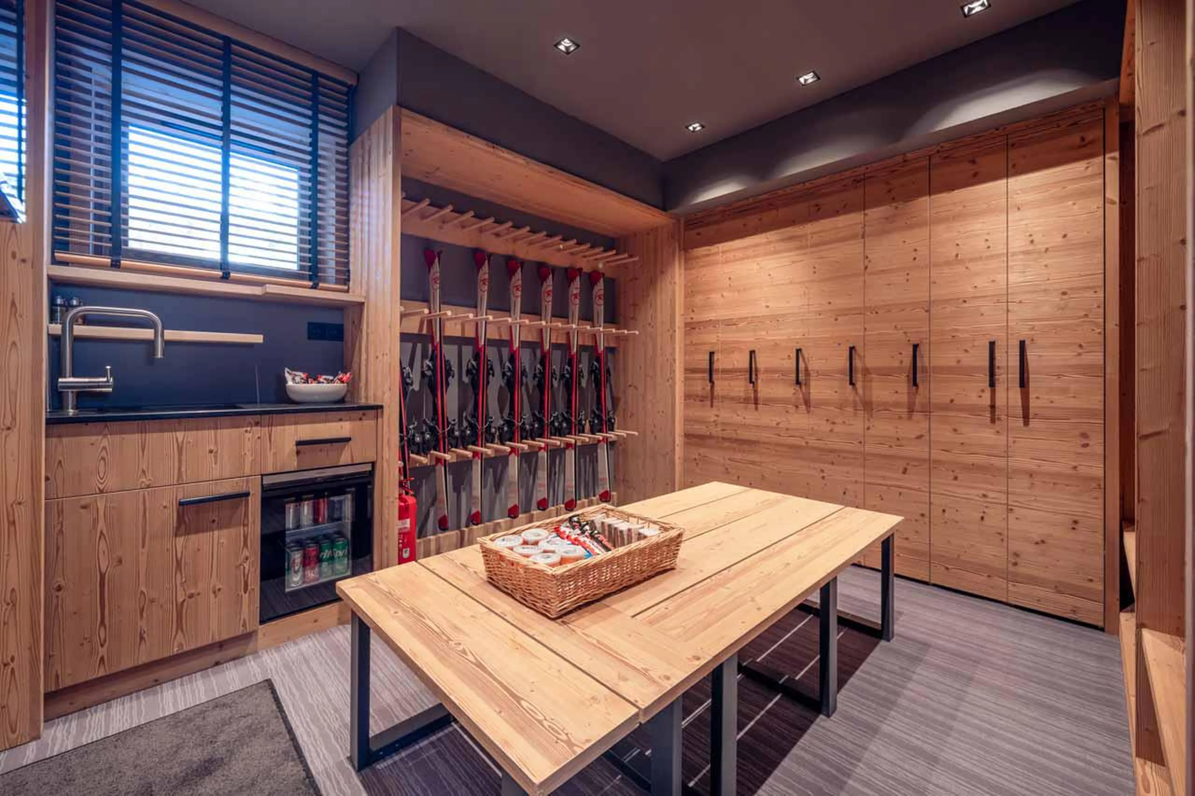 Ski room with heated boot racks and TV at Chalet Harmony in Meribel