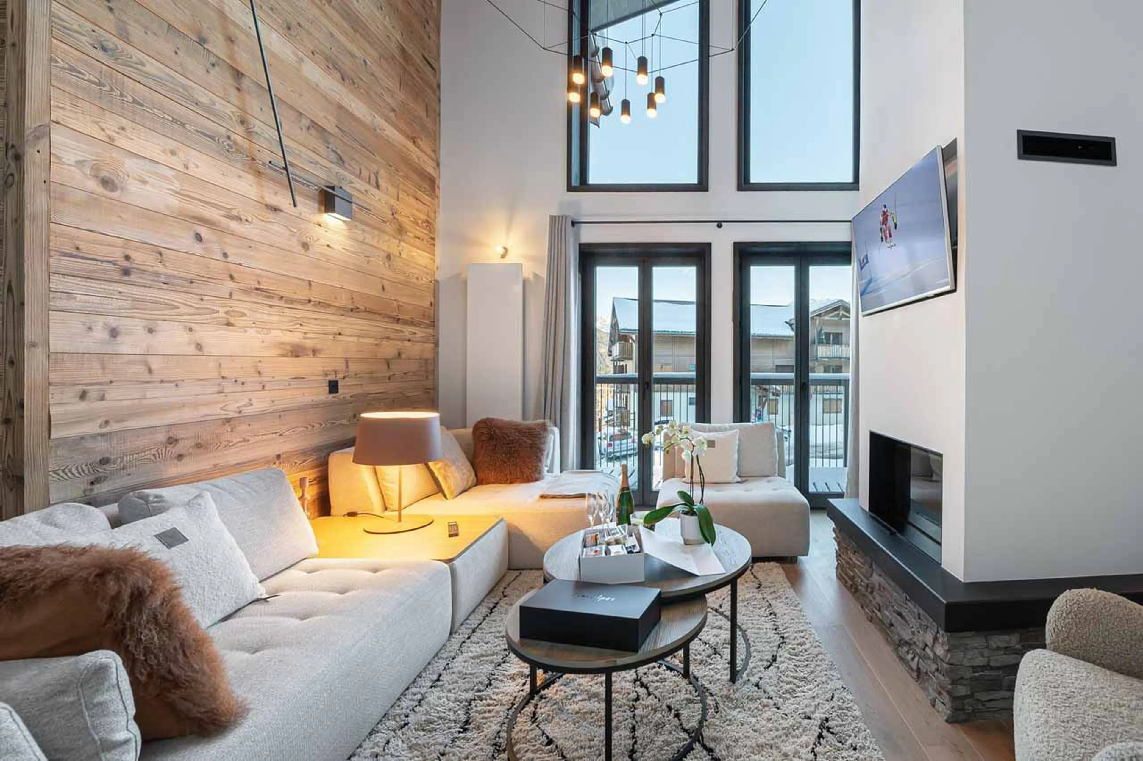 Sofas and fireplace in living area of Chalet Illi in Courchevel 1550