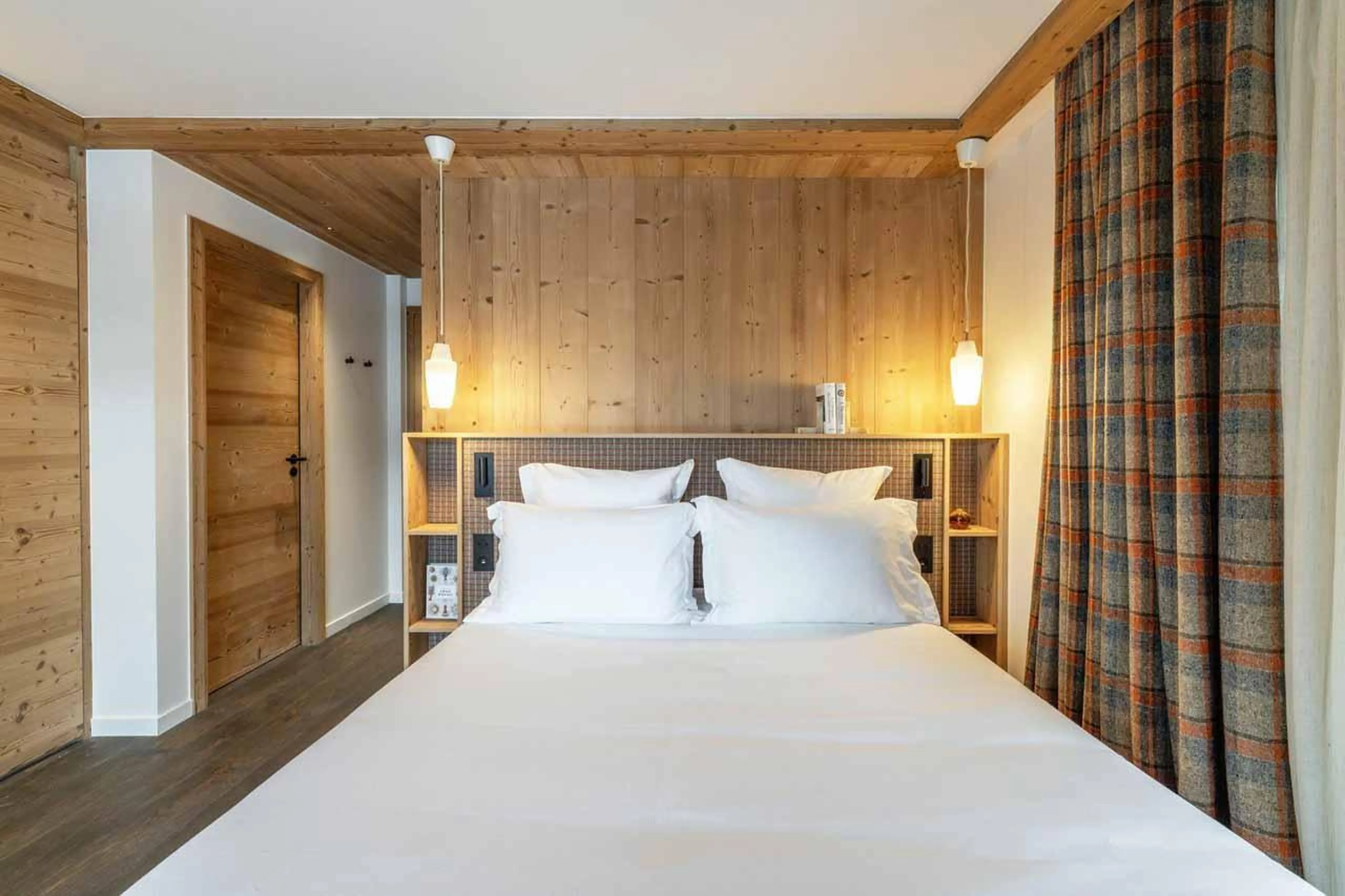 Double bedroom with shelving and pendant lighting in Chalet Irbis, Courchevel Le Praz