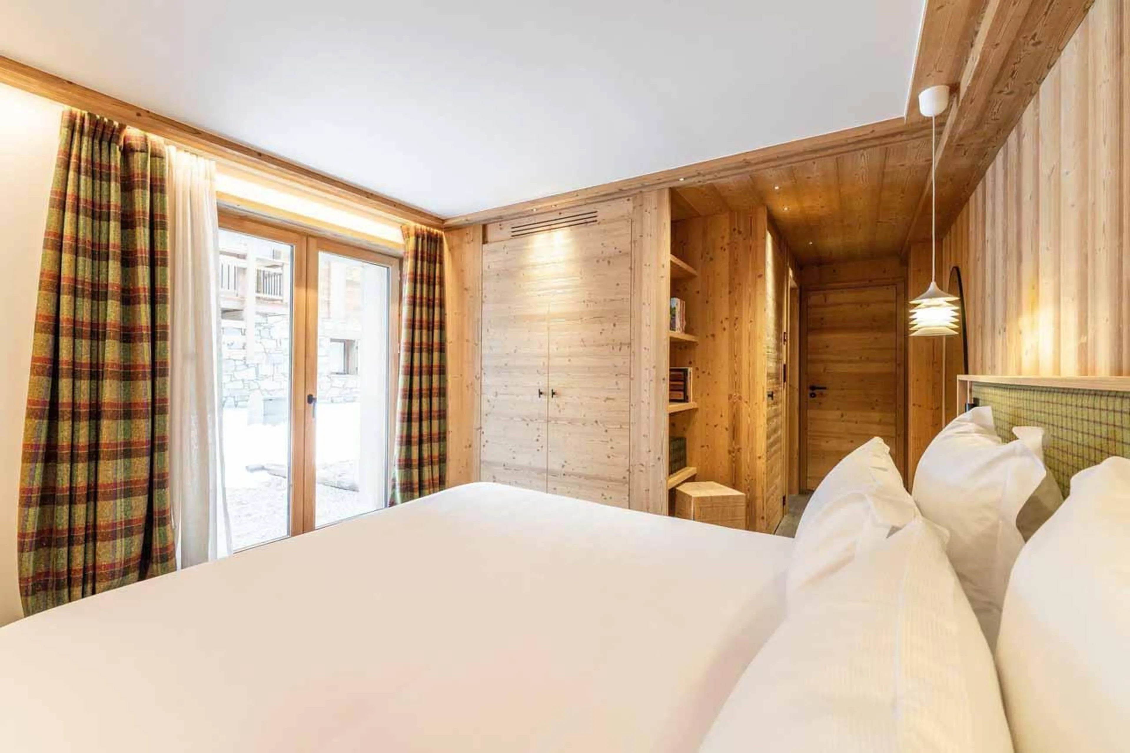 Double bedroom with French doors in Chalet Irbis, Courchevel Le Praz