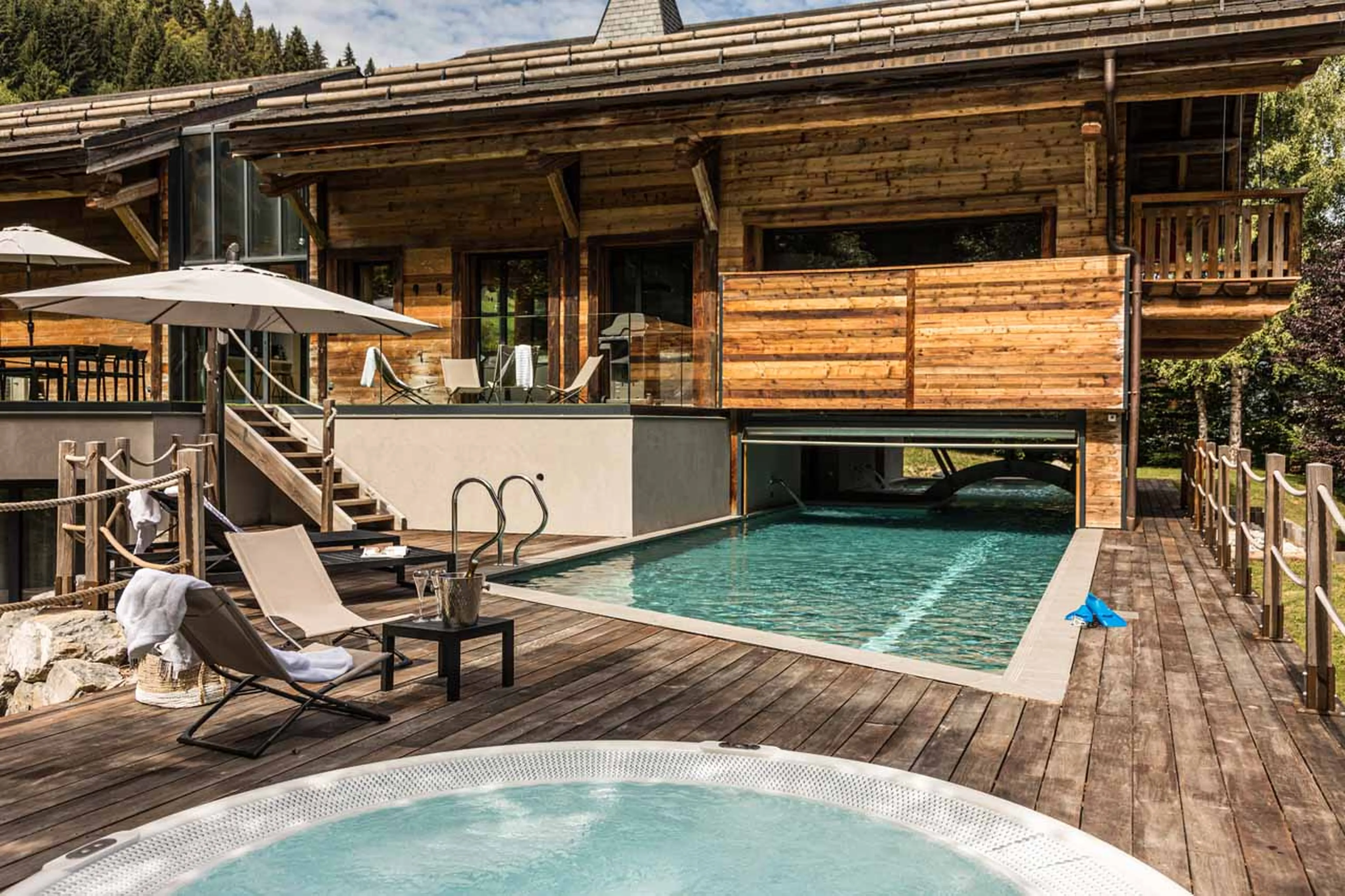 Indoor/outdoor pool and hot tub at Chalet Joux Plane in Morzine in summer