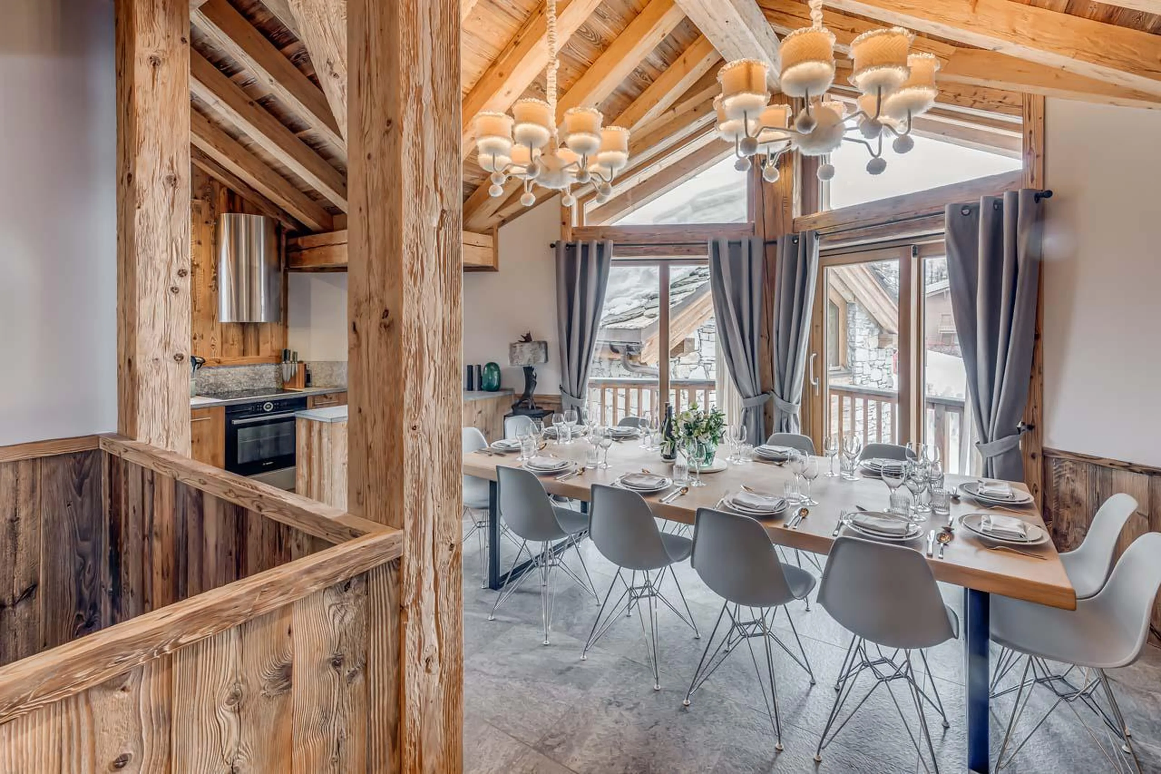 Dining area with access to south-facing balcony at Chalet Juno in Val d'Isere