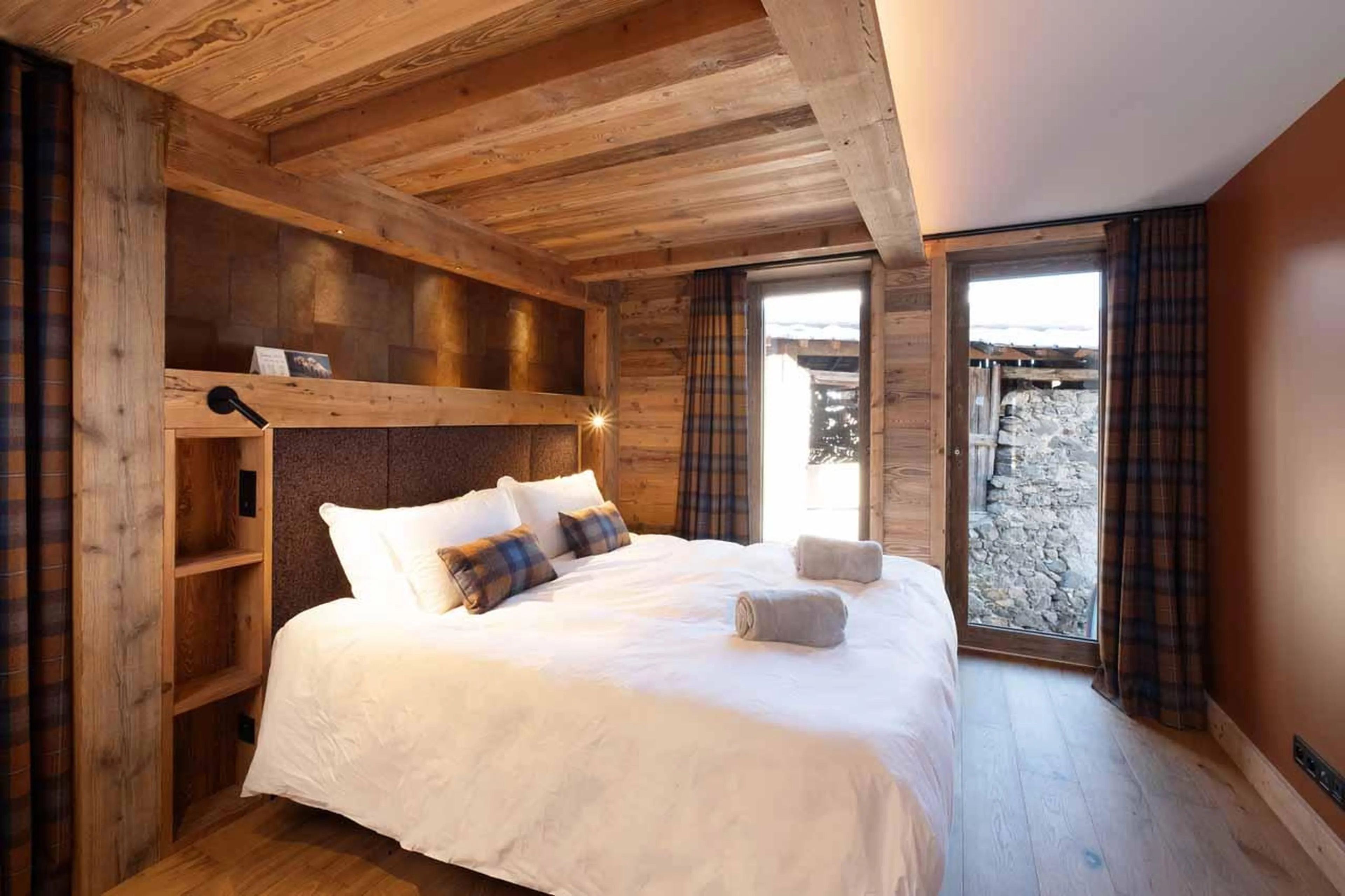 Double bedroom with floor-to-ceiling windows in Chalet Kalinka, Meribel