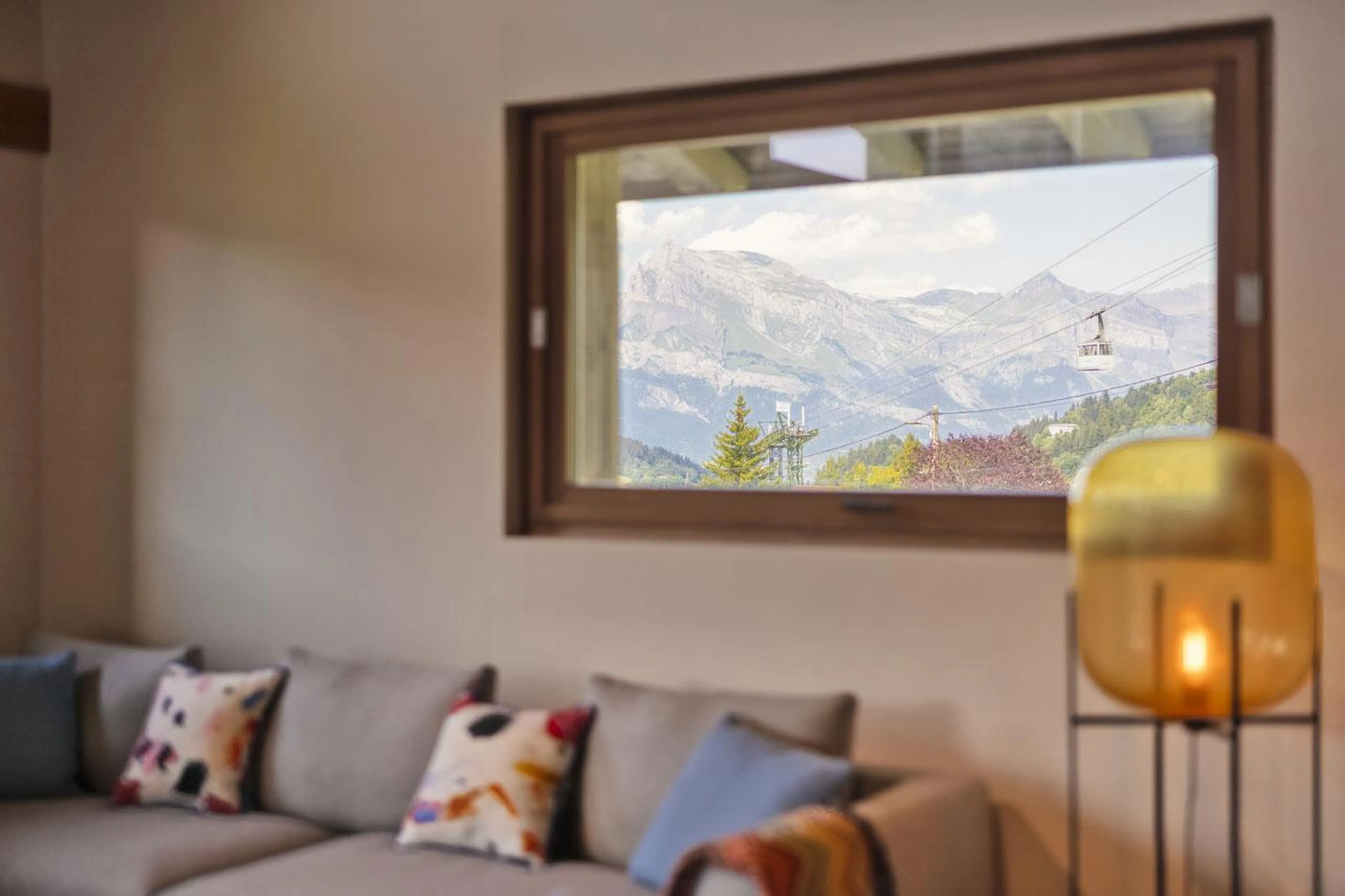 Living area with window overlooking Rochebrune cable car at Chalet Kantaa in Megeve