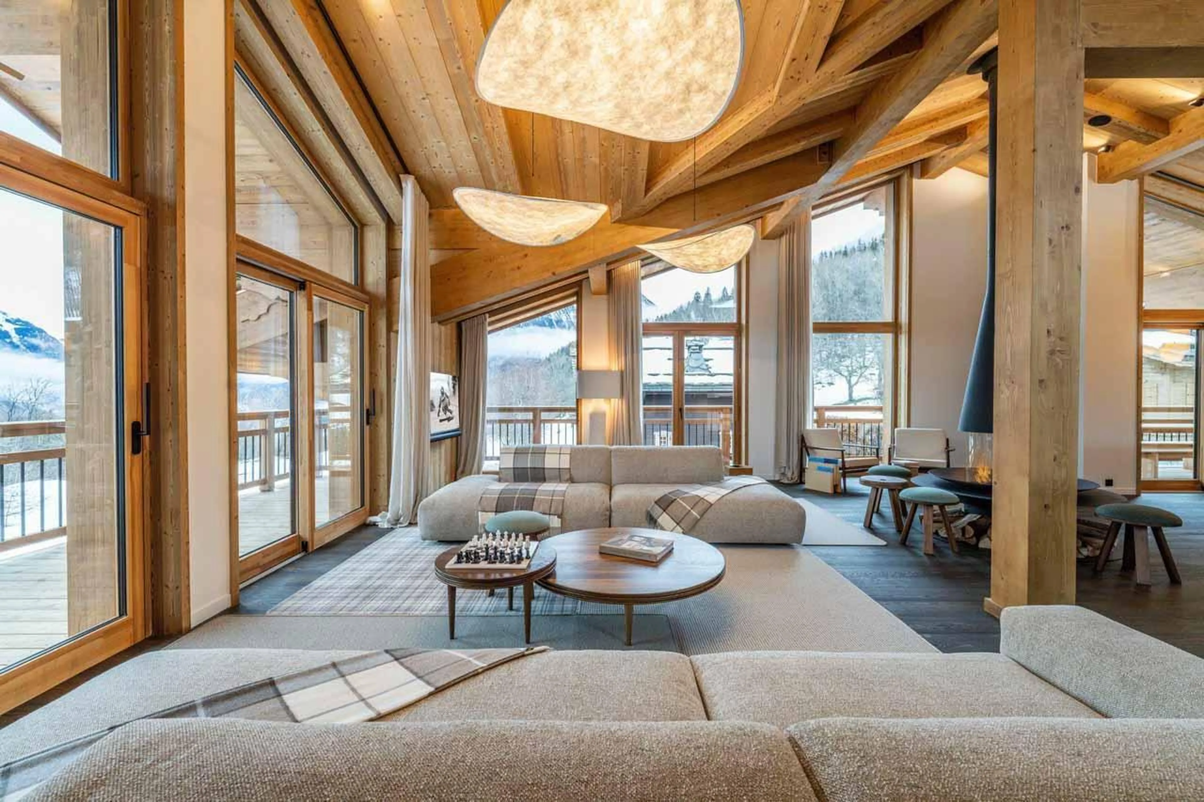 Sofas and sliding glass doors leading to balcony in Chalet Khoton, Courchevel Le Praz
