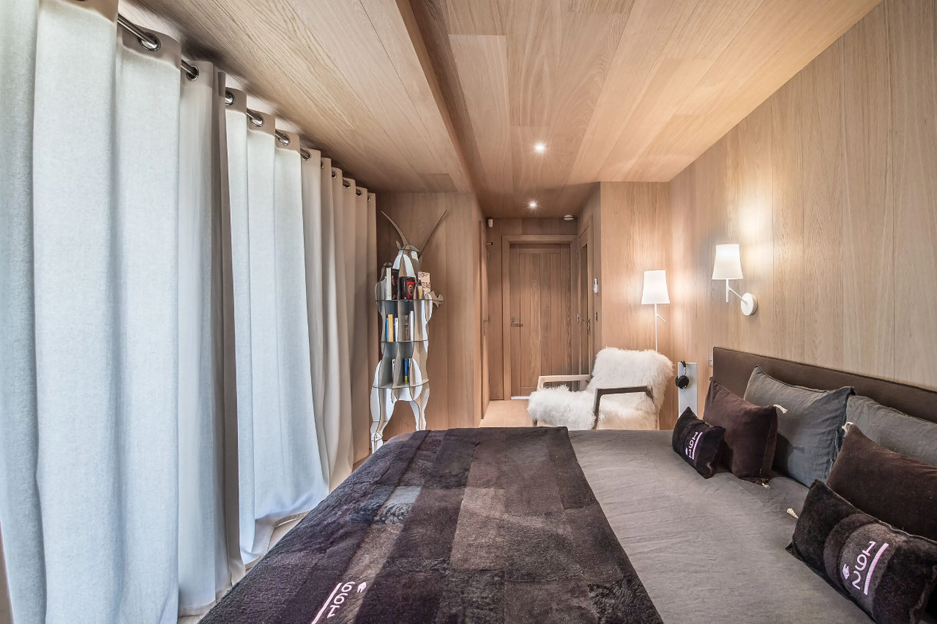 Bedroom with double bed and en-suite shower room in Chalet Kibo in Courchevel 1550