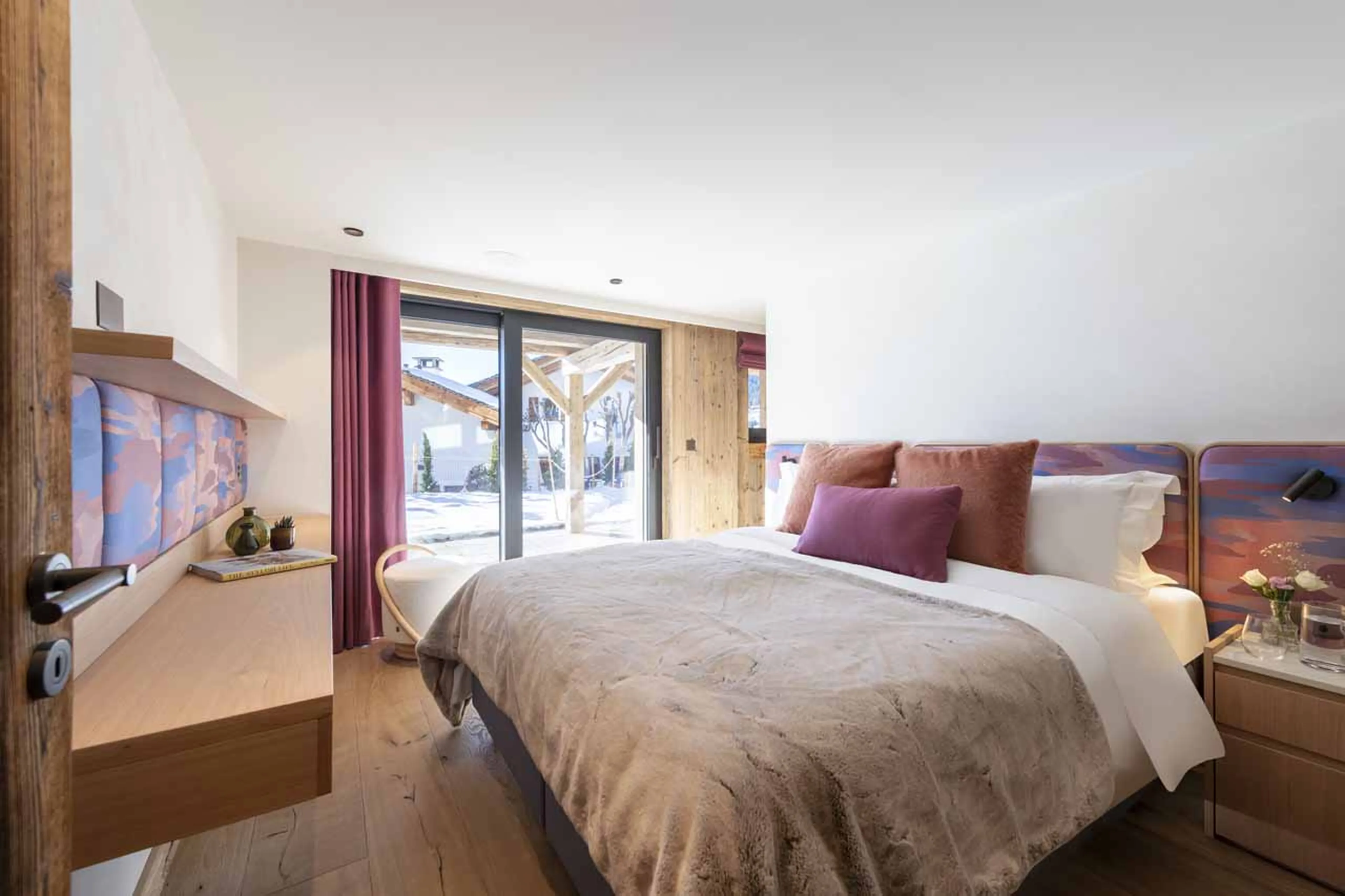 Double bedroom with glass doors in Chalet Kitsilano, Verbier