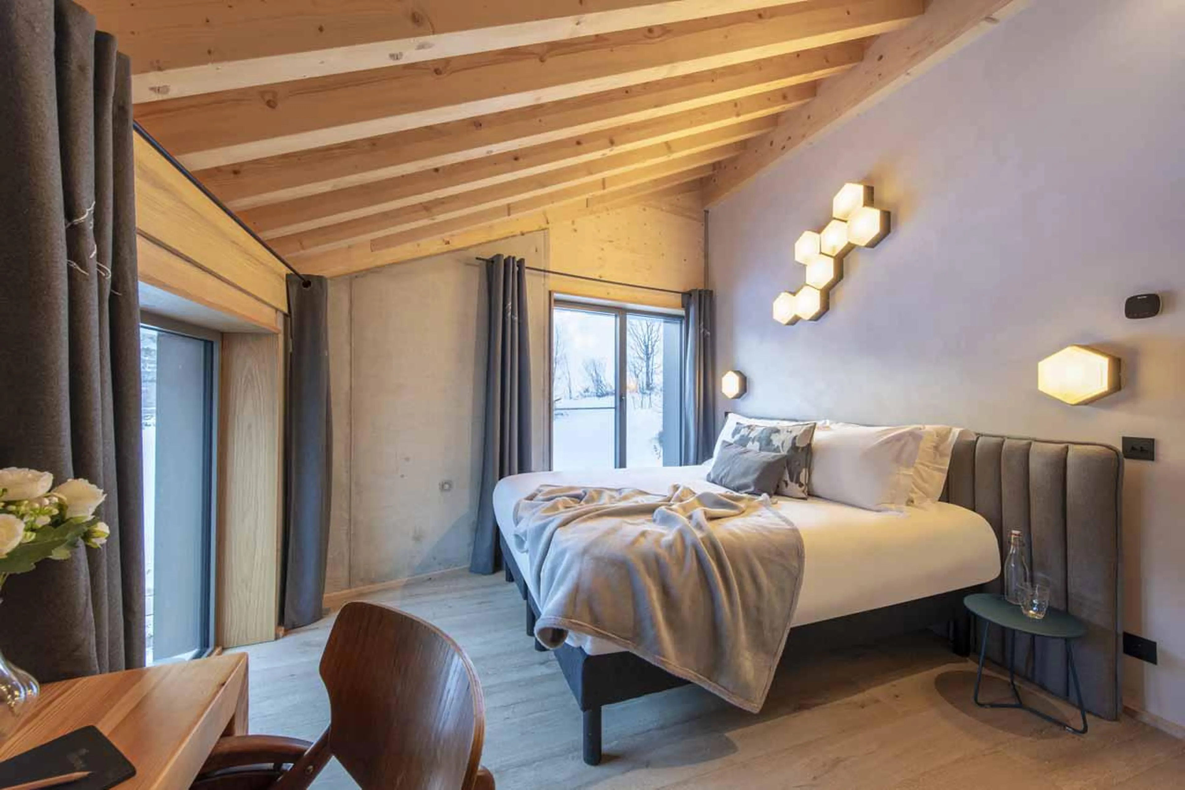 Bedroom with wooden beamed ceiling at Chalet Kitsune in Val d'Isere