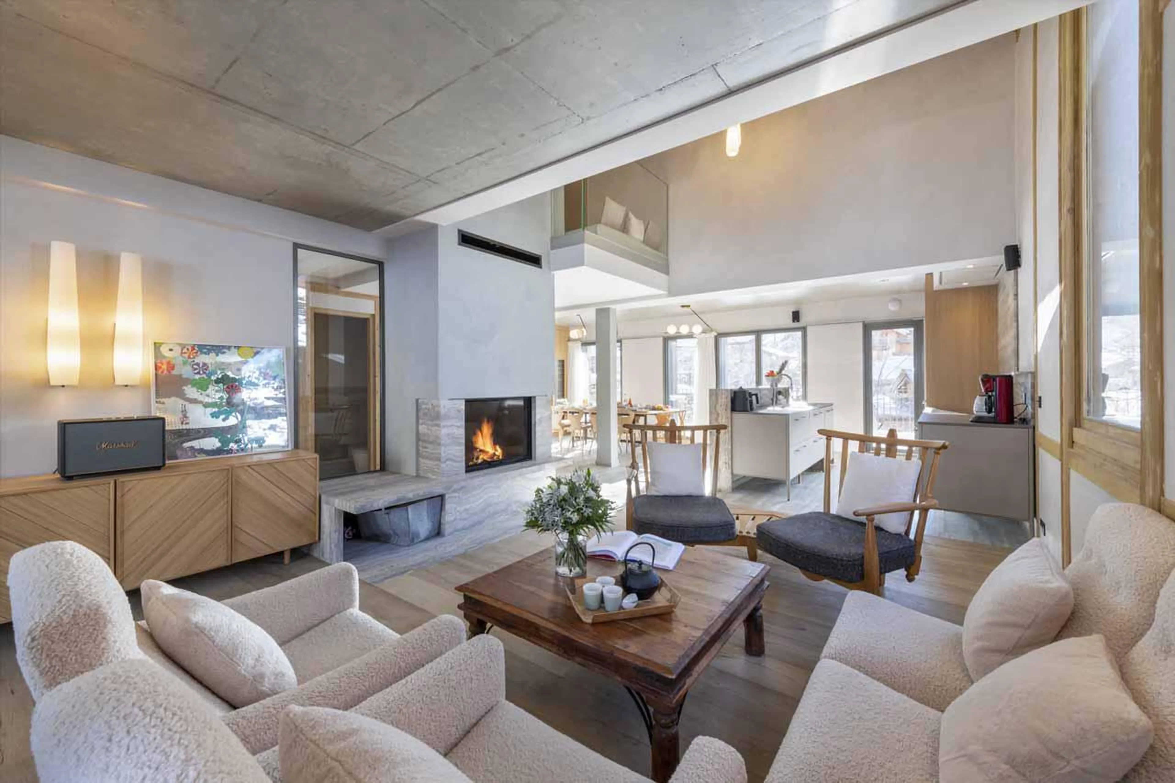 Wood-burning fireplace central within the living space at Chalet Kitsune in Val d'Isere