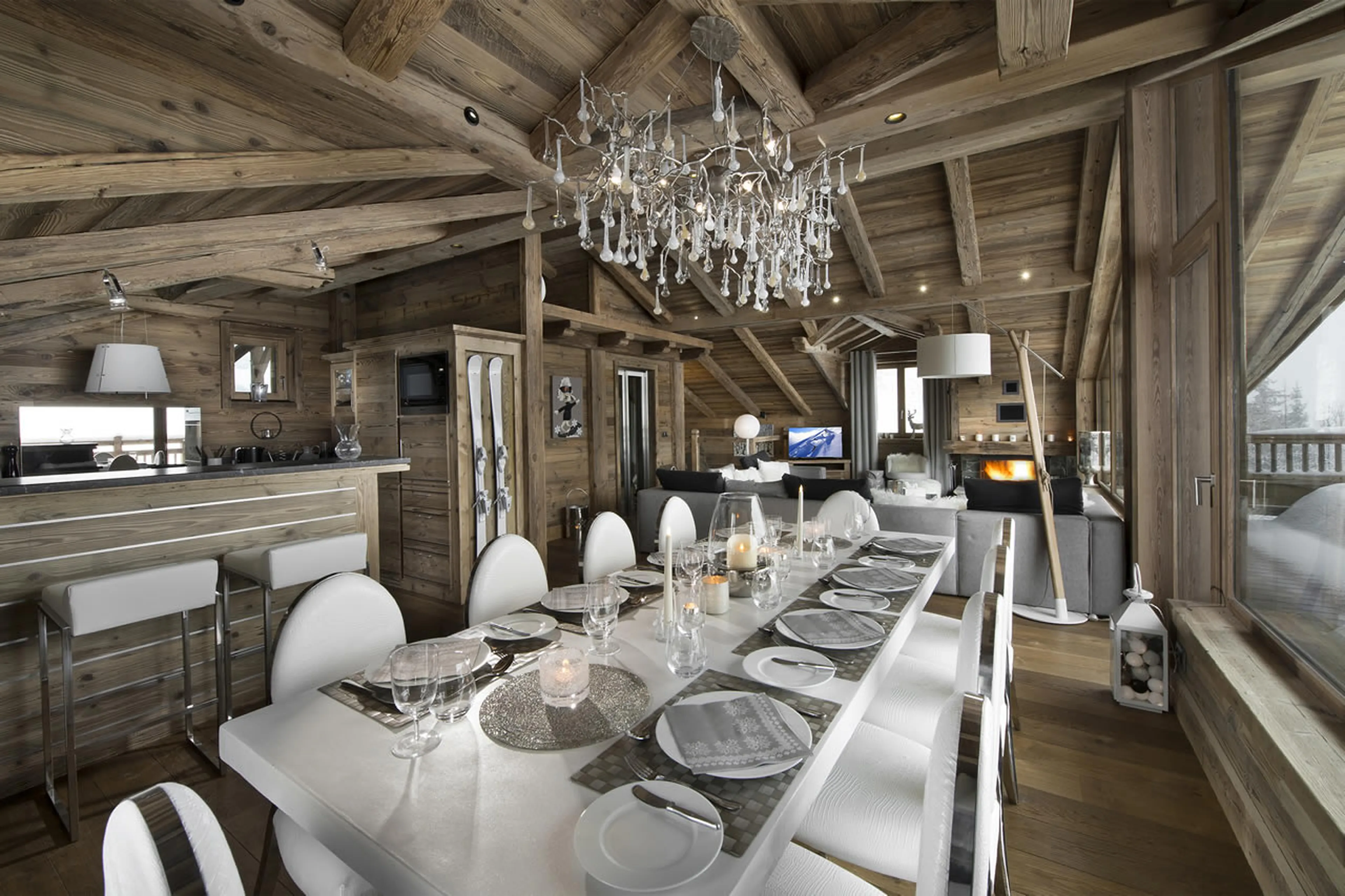Dining room next to open plan kitchen with breakfast bar in Chalet L’Or Blanc in Courchevel 1550
