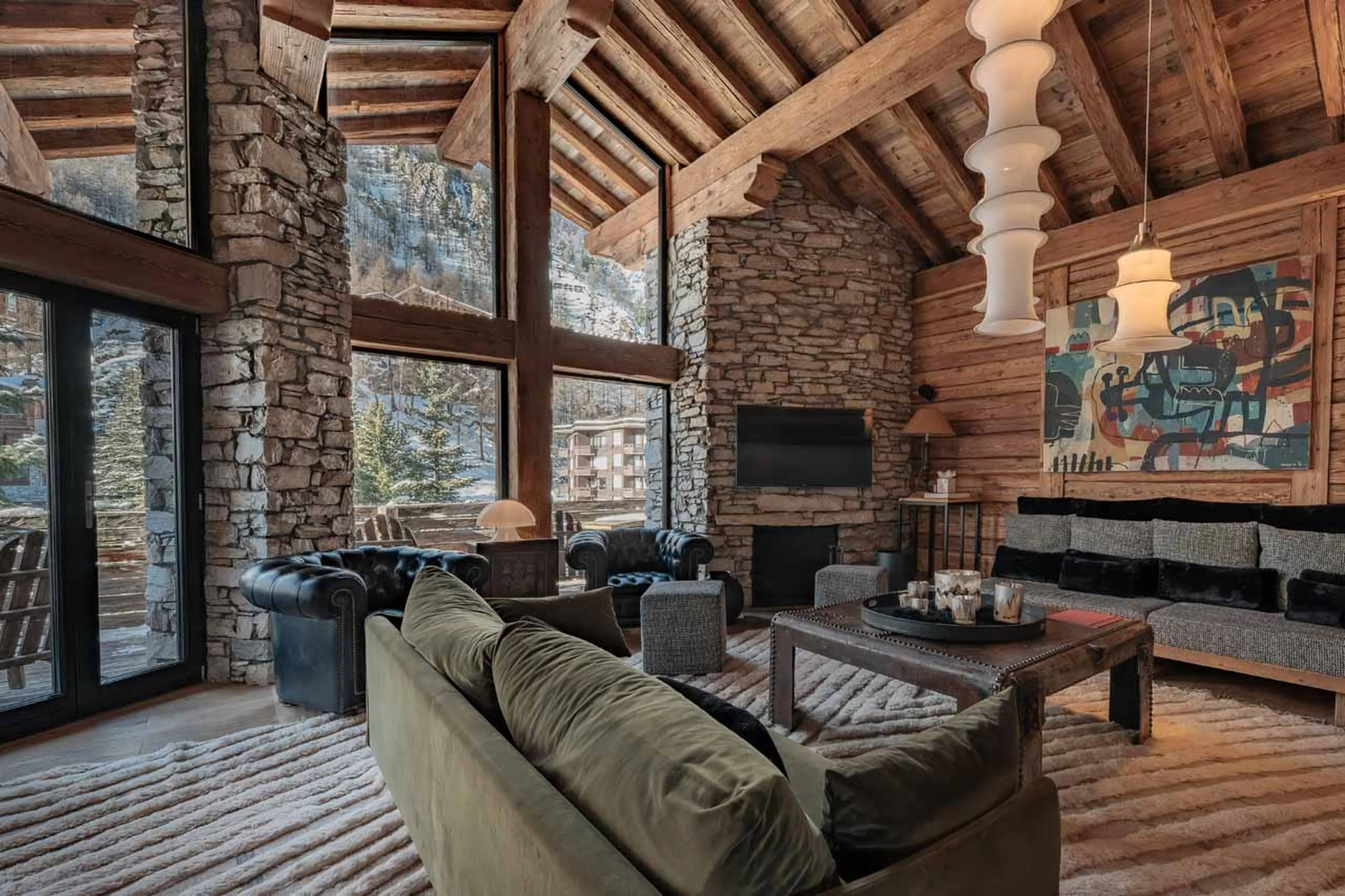 Living area with stone fireplace at Chalet La Face in Val d'Isere