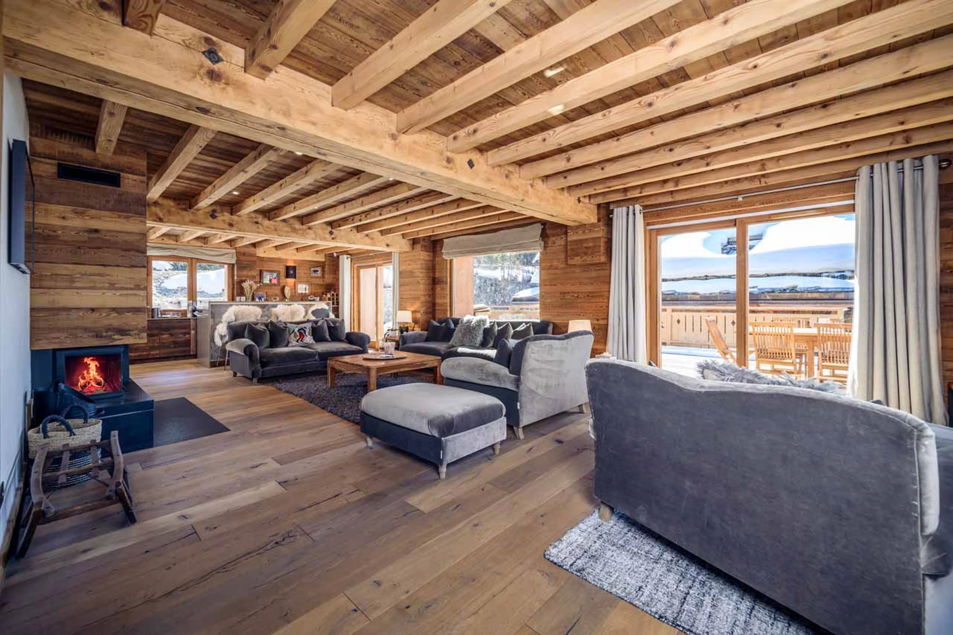 Comfortable sofas in front of a cosy fireplace in Chalet La Folie, Meribel
