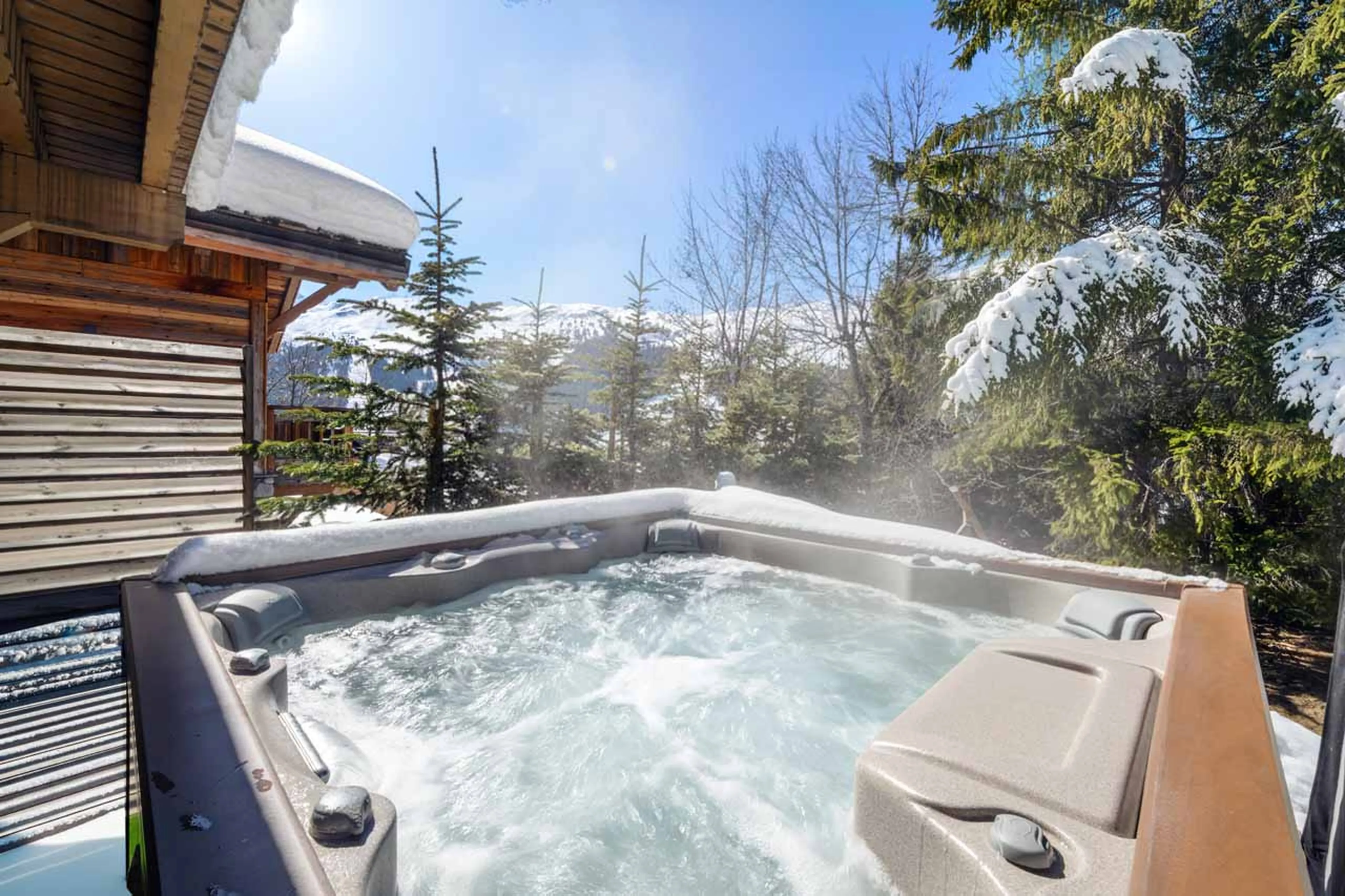 Outdoor hot tub and seating in Chalet La Folie, Meribel