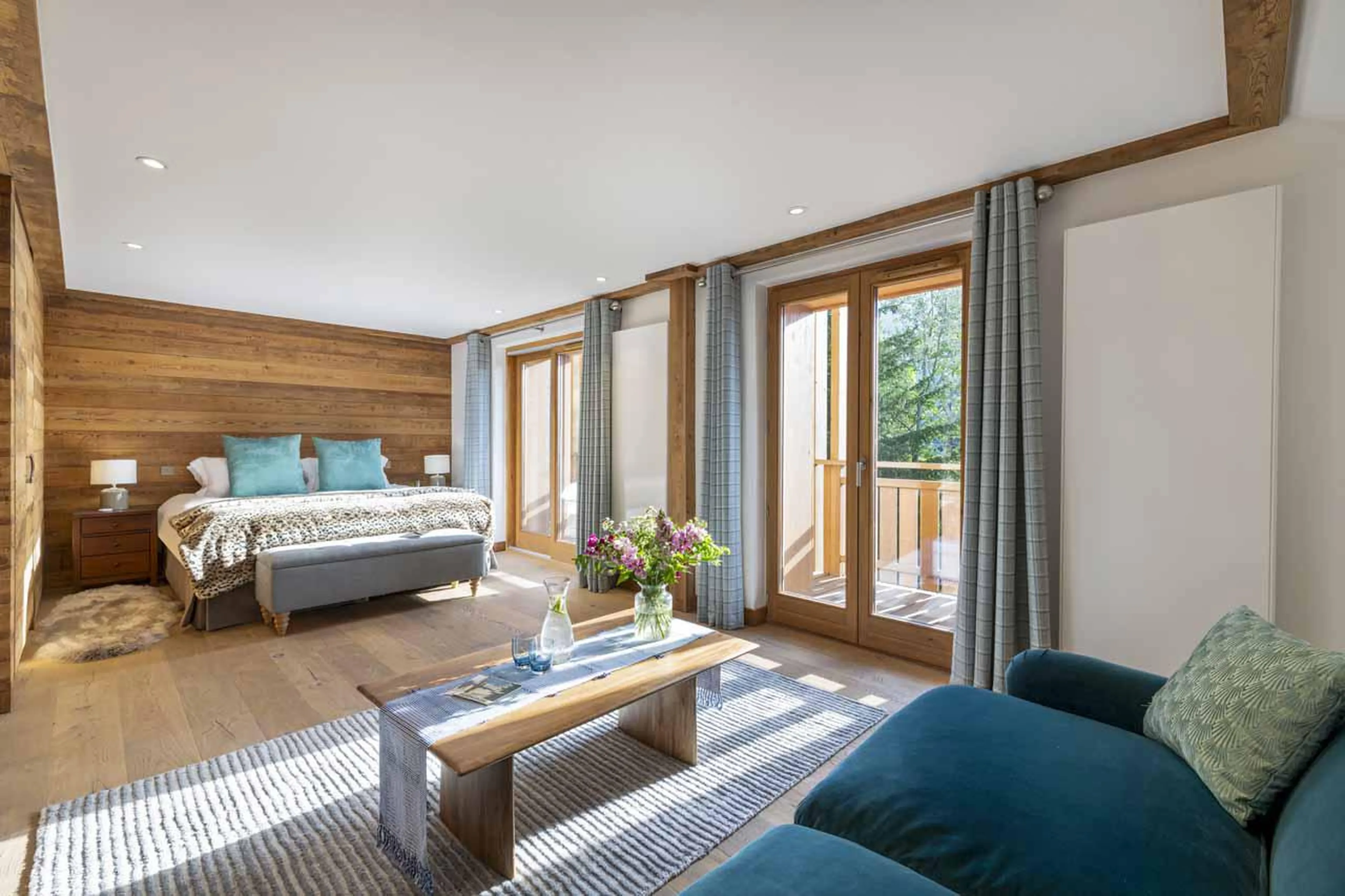Master bedroom with sofa and  private balcony in Chalet La Folie, Meribel