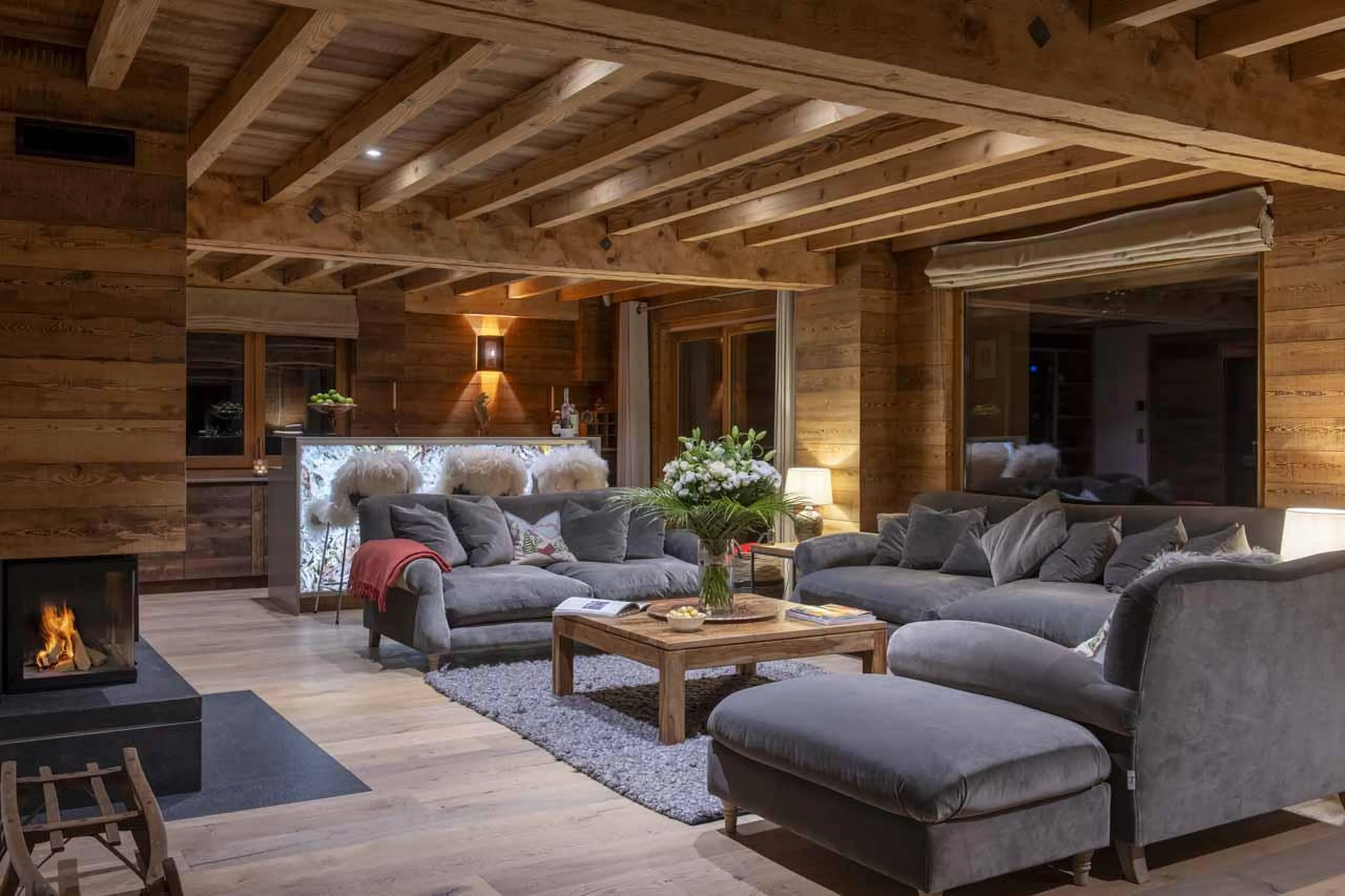 Comfortable sofas in front of a cosy fireplace in Chalet La Folie, Meribel