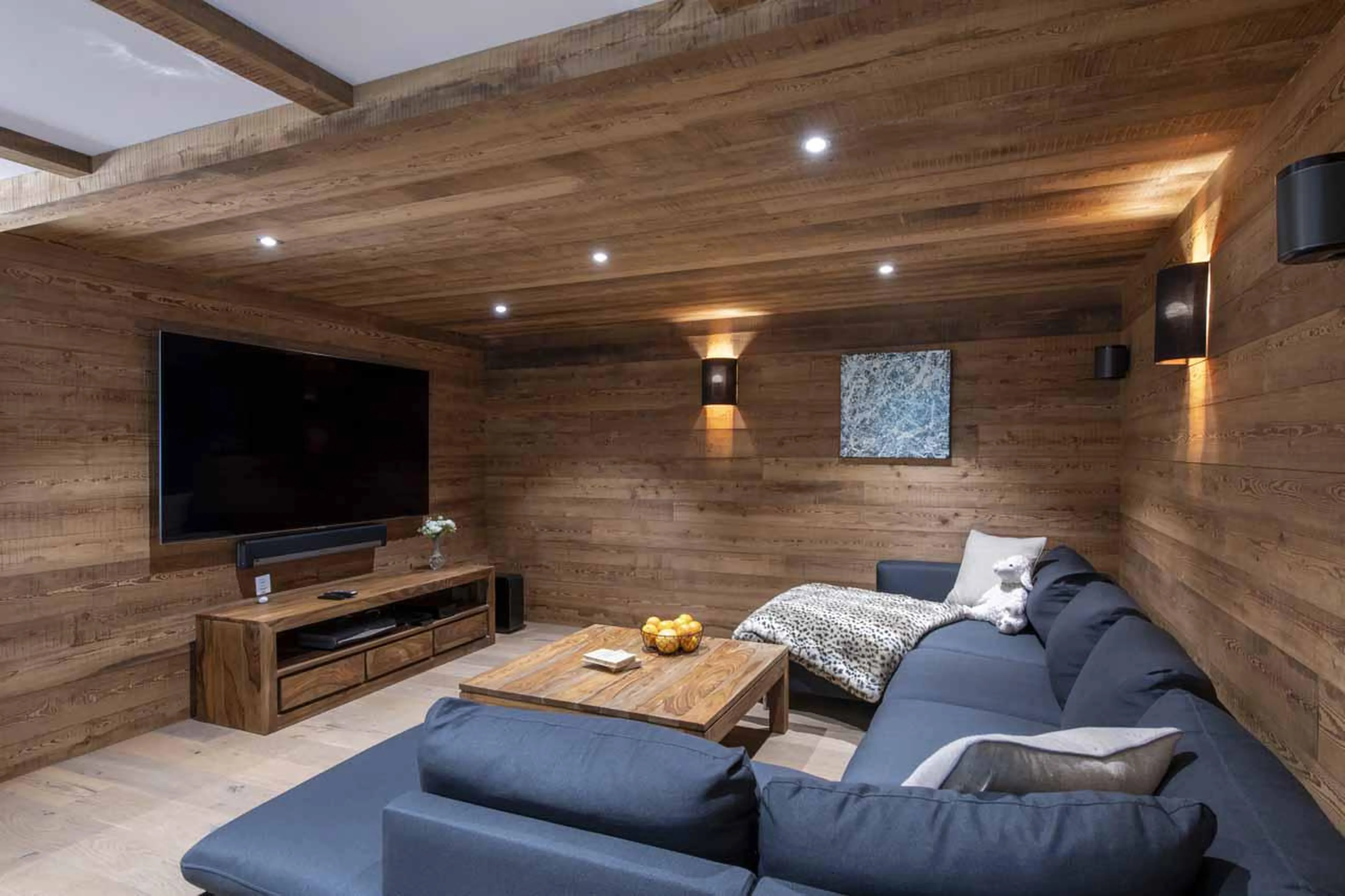 Cosy TV snug with wrap-around sofa in Chalet La Folie, Meribel