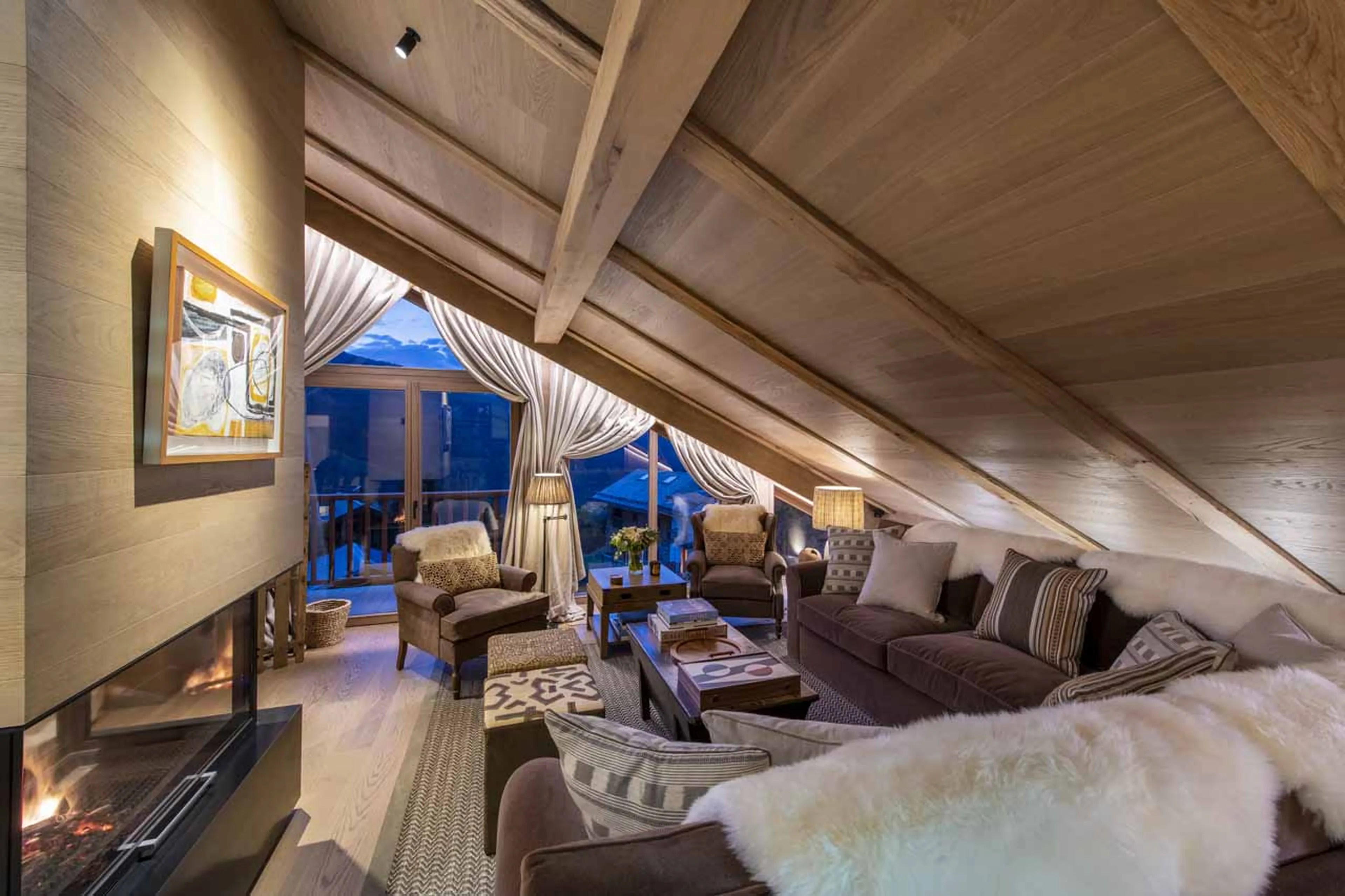 Sofas and fireplace at Chalet La Loze in Meribel