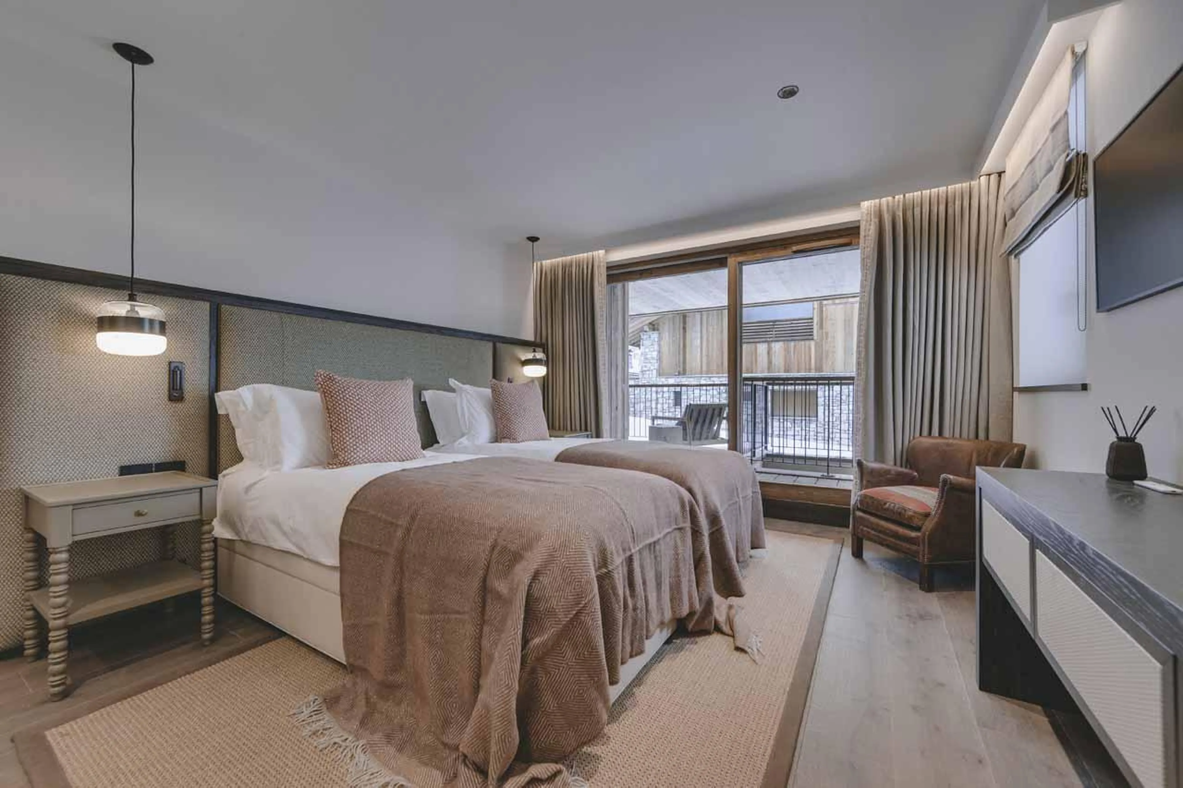 Twin bedroom with sliding glass doors at Chalet La Tene, Val d'Isere