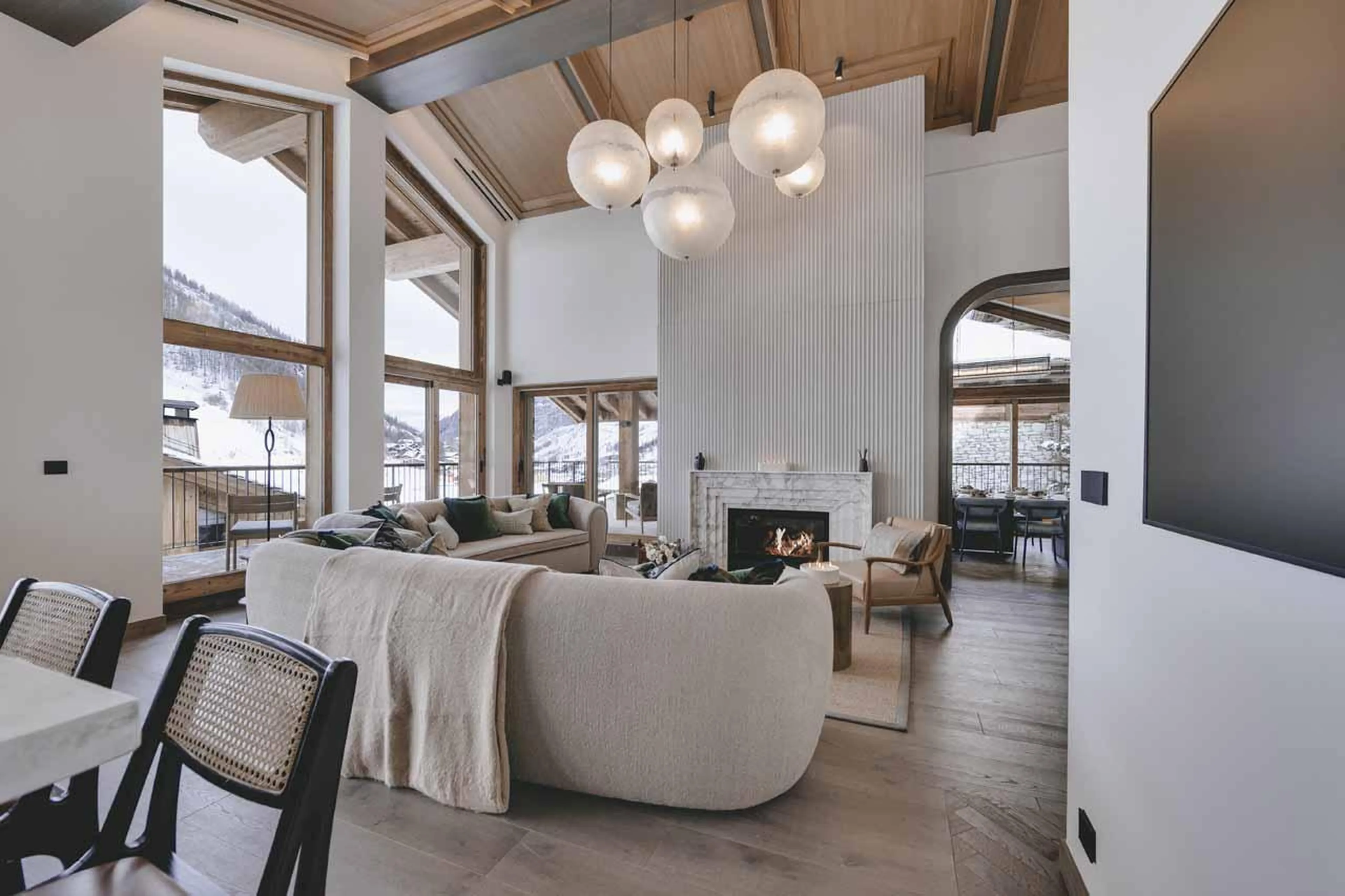 Comfortable sofas in front of a fireplace at Chalet La Tene, Val d'Isere