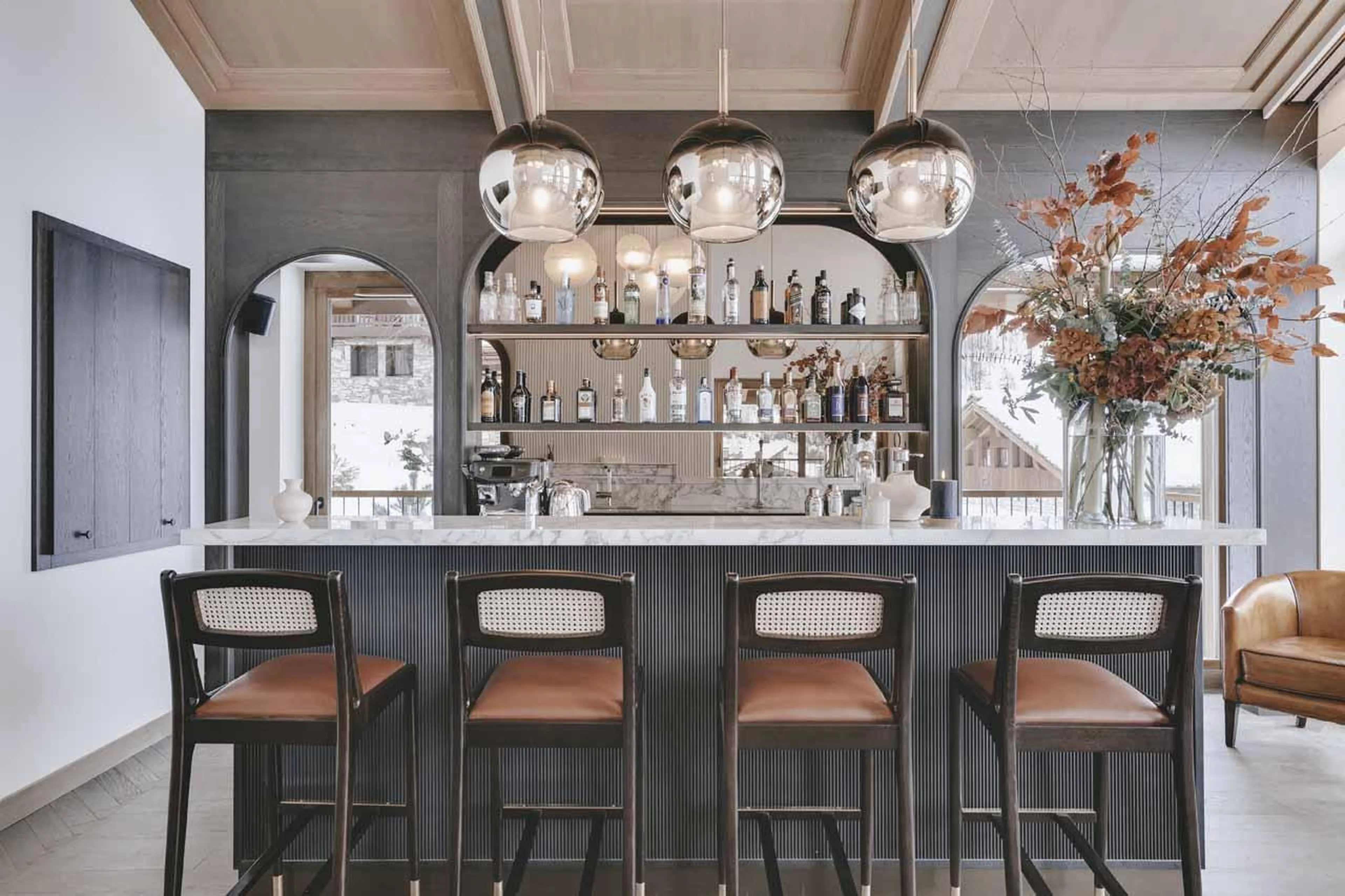 Professional bar with high seating and stylish lighting at Chalet La Tene, Val d'Isere