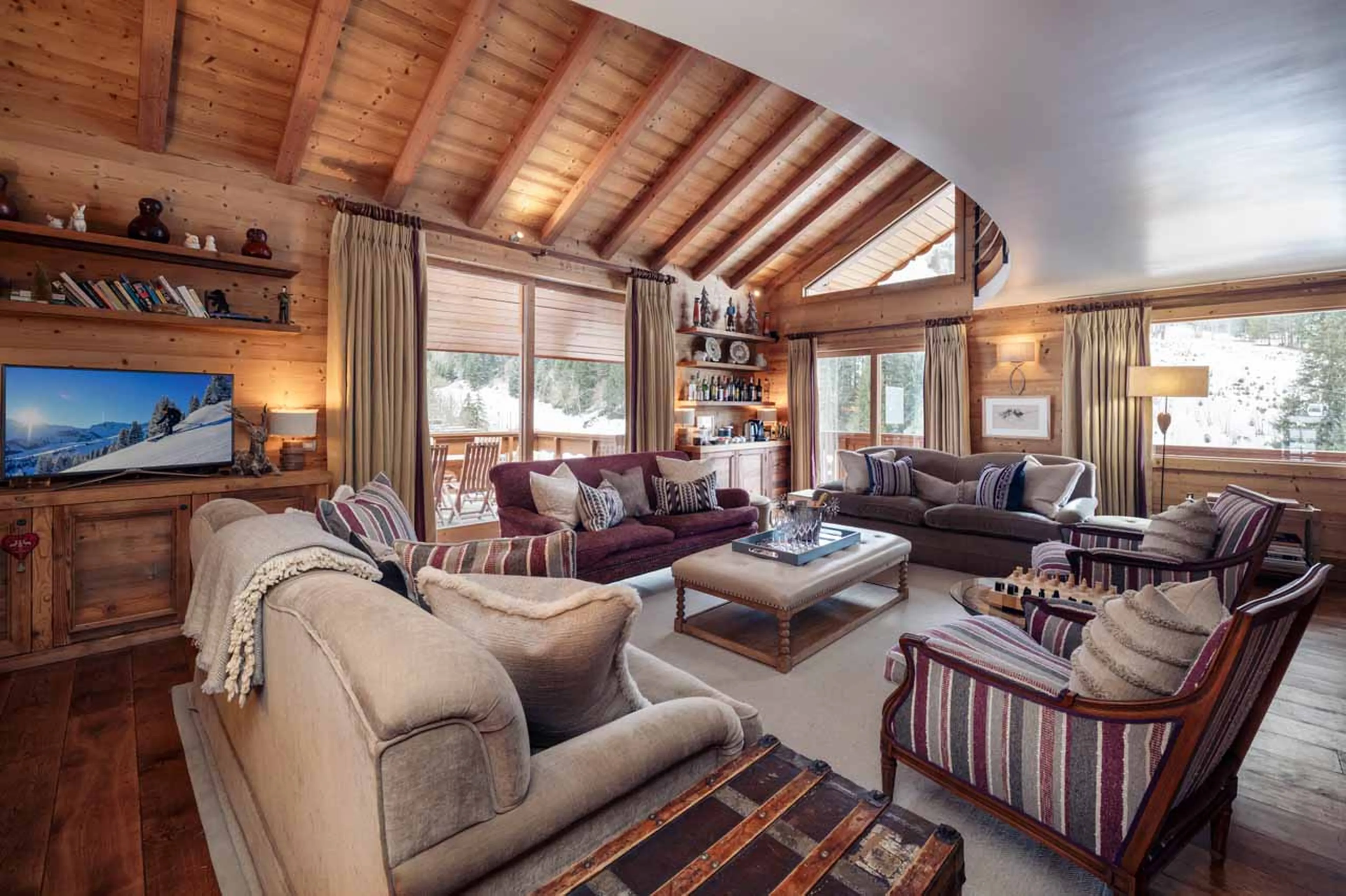 Large open-plan living space with cosy sofa area at Chalet Lapin Blanc in Meribel