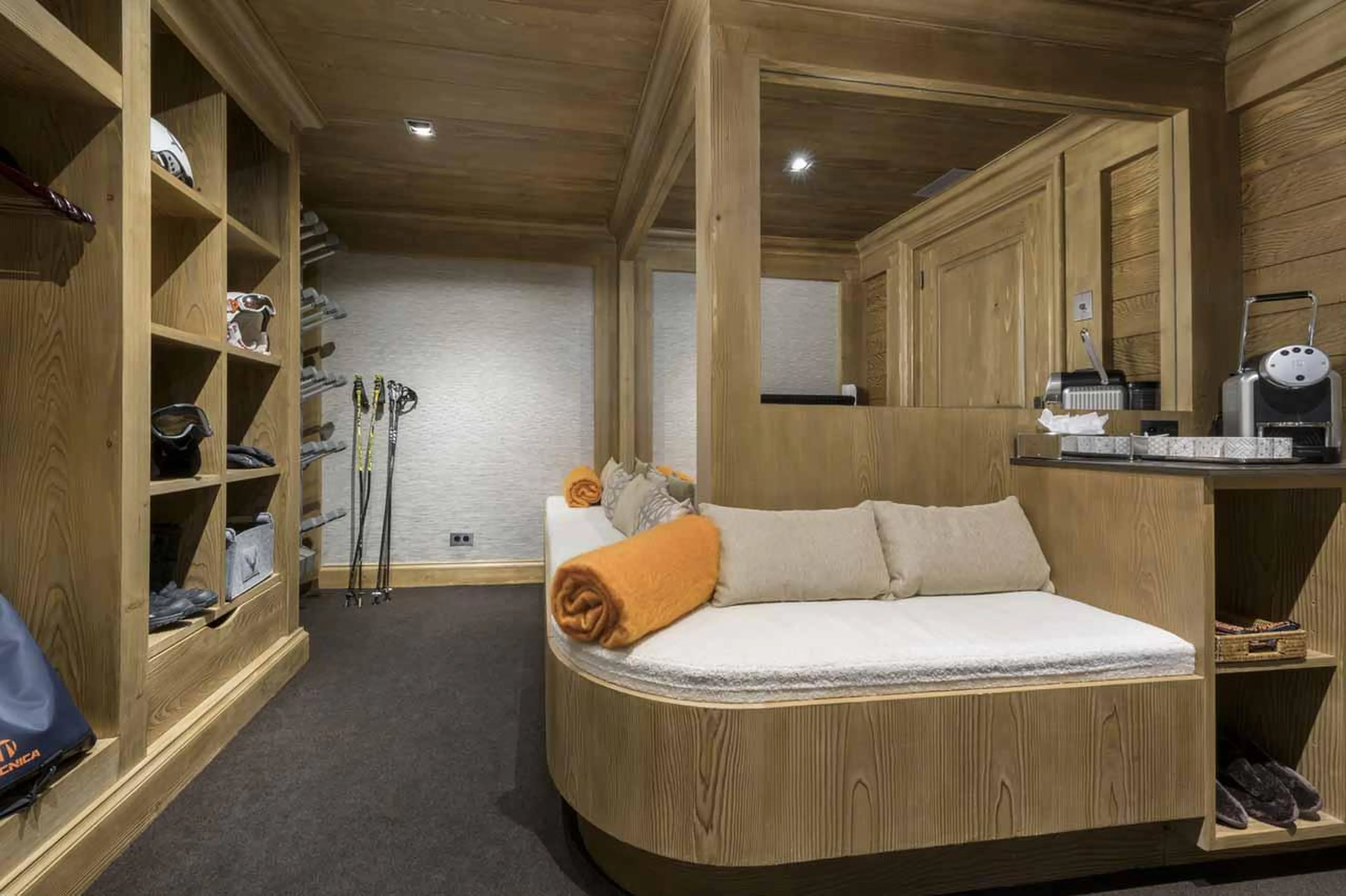 Spacious ski room with boot warmers and seating in Chalet Le Blanchot in Courchevel 1850