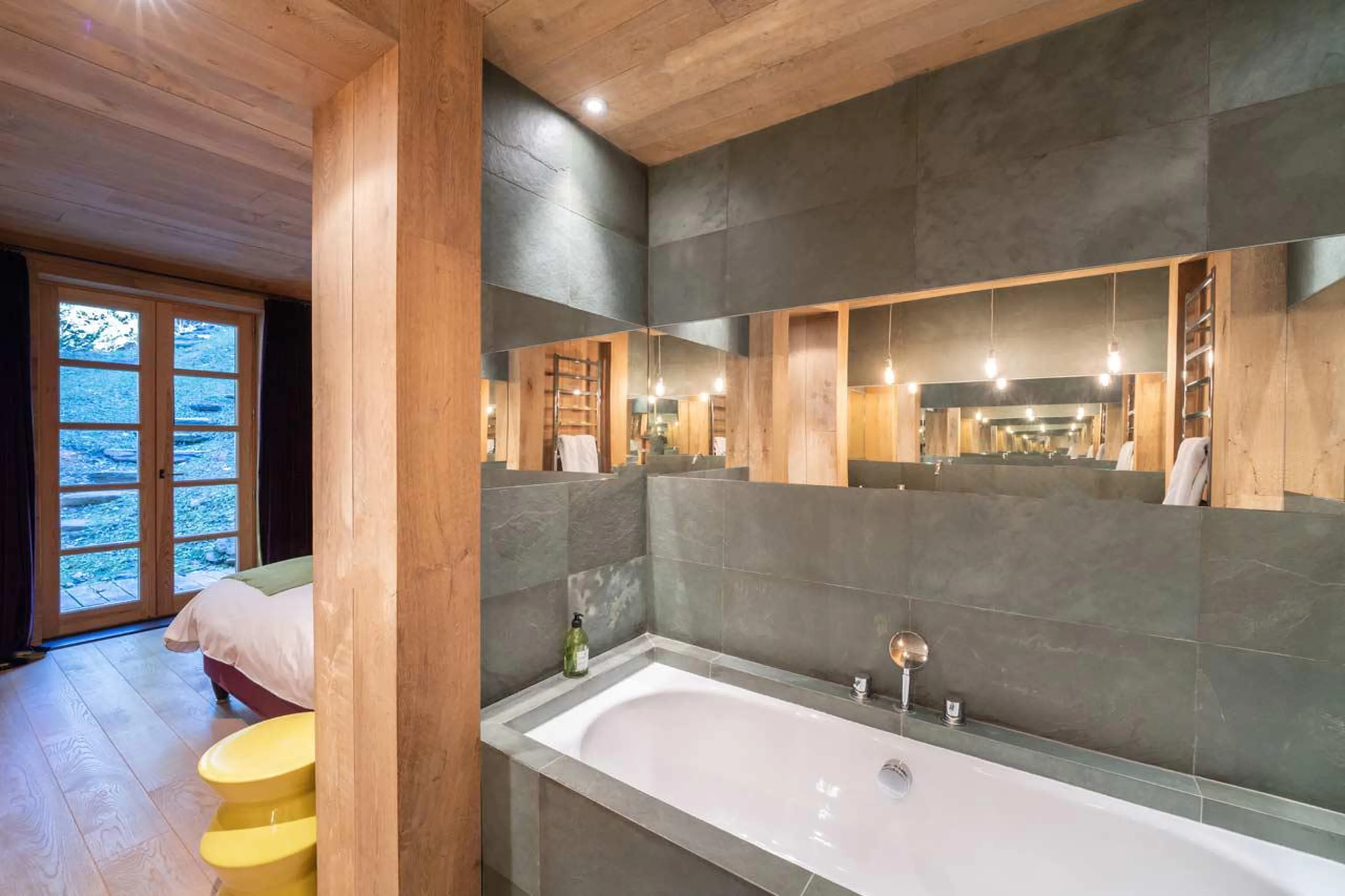 En-suite bathroom with bath at Le Grand Cerf in Meribel