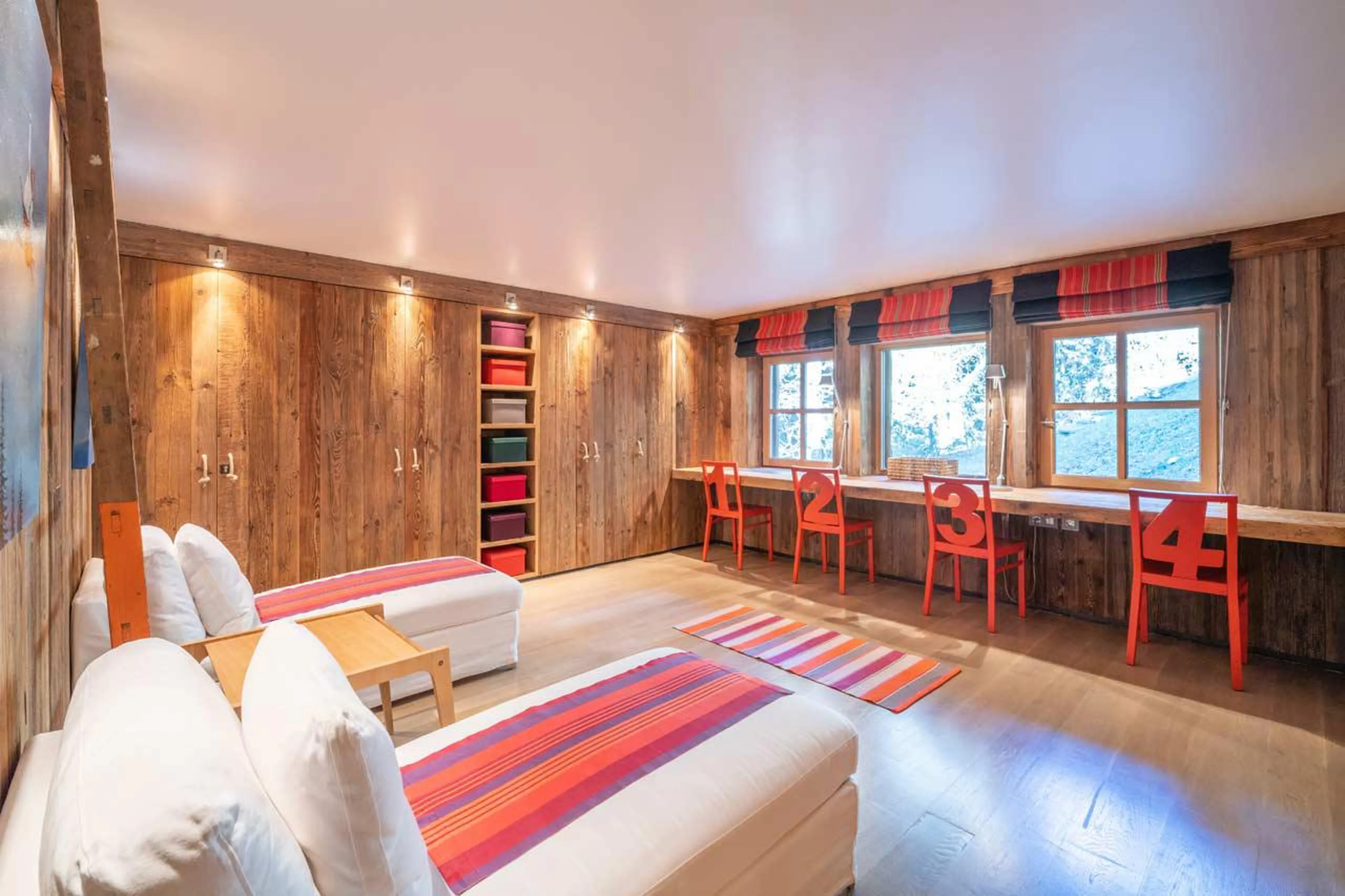 Spacious bedroom with plentiful storage and desk space at Le Grand Cerf in Meribel