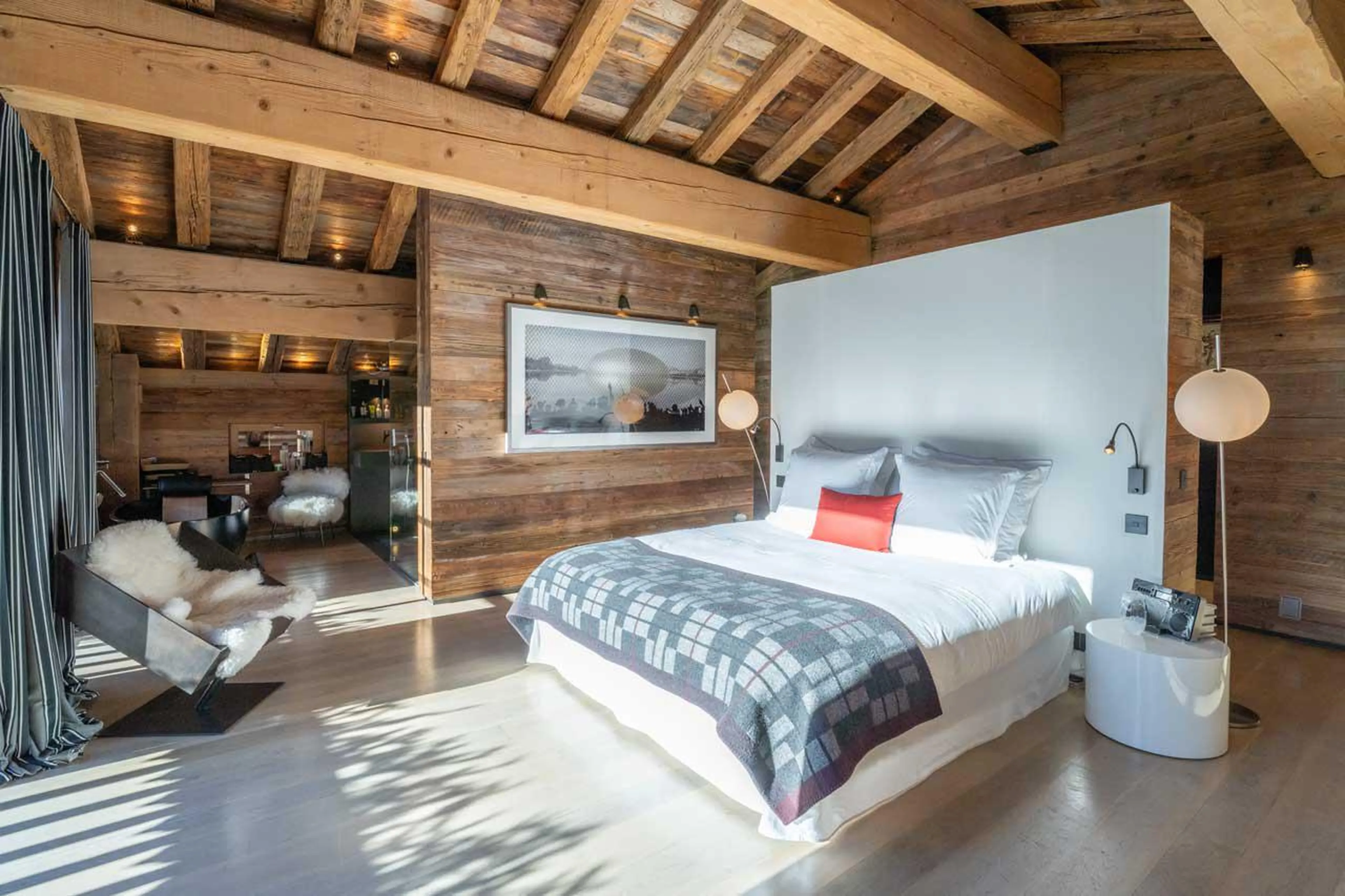 Double bedroom with wooden beamed ceiling at Le Grand Cerf in Meribel