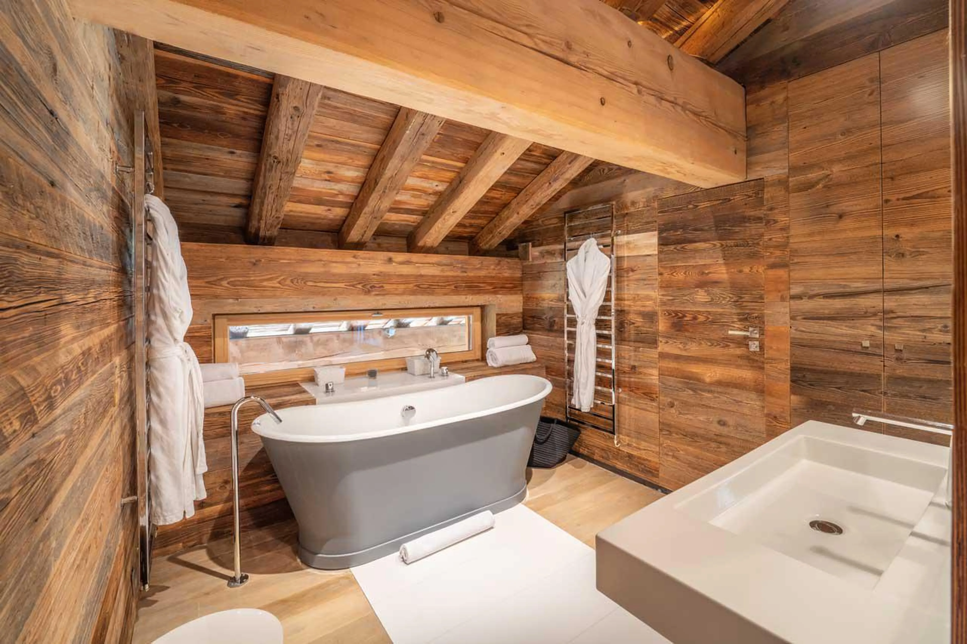 En-suite bathroom with bath at Le Grand Cerf in Meribel