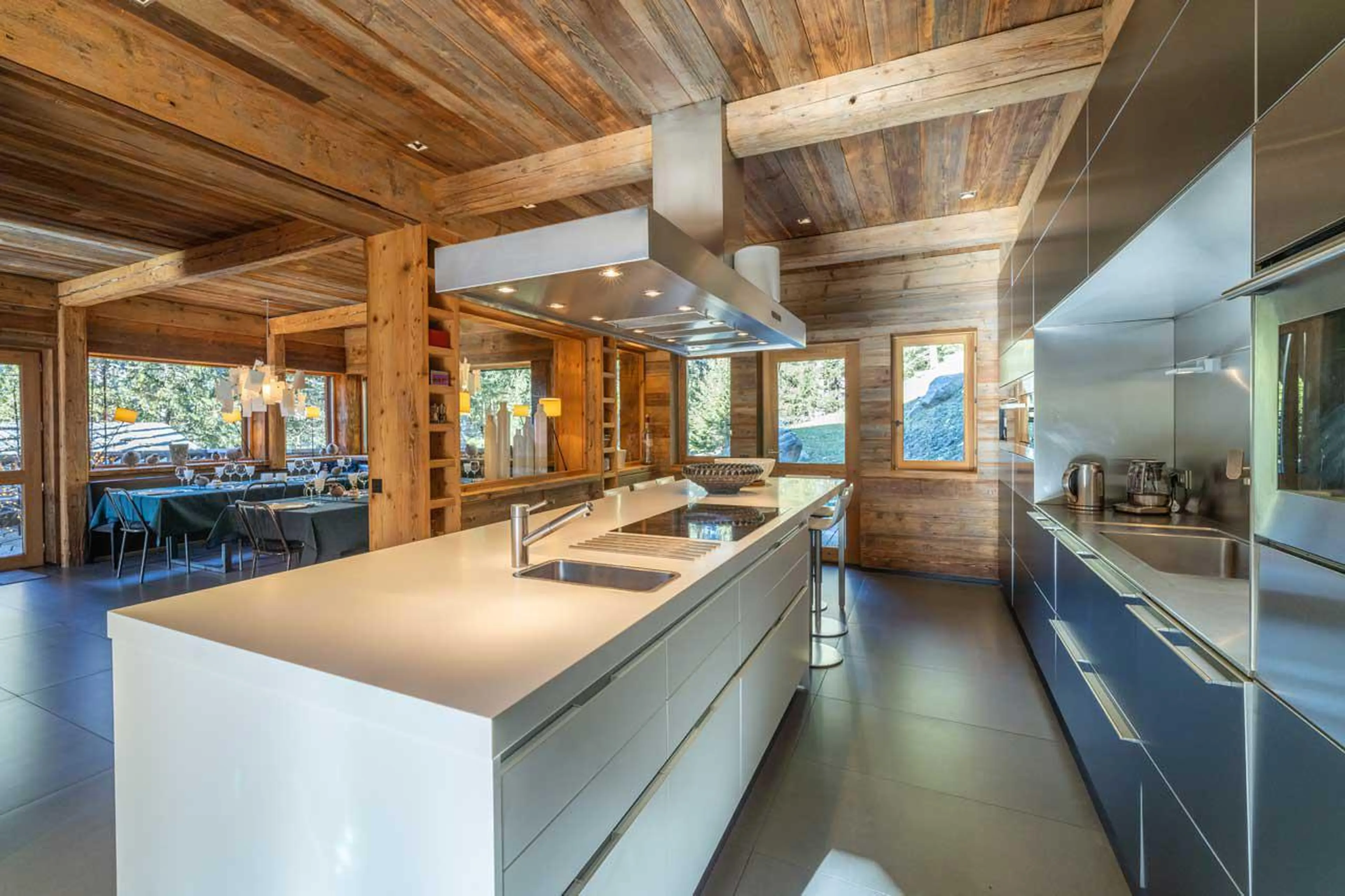 Open-plan kitchen adjoining dining area at Le Grand Cerf in Meribel