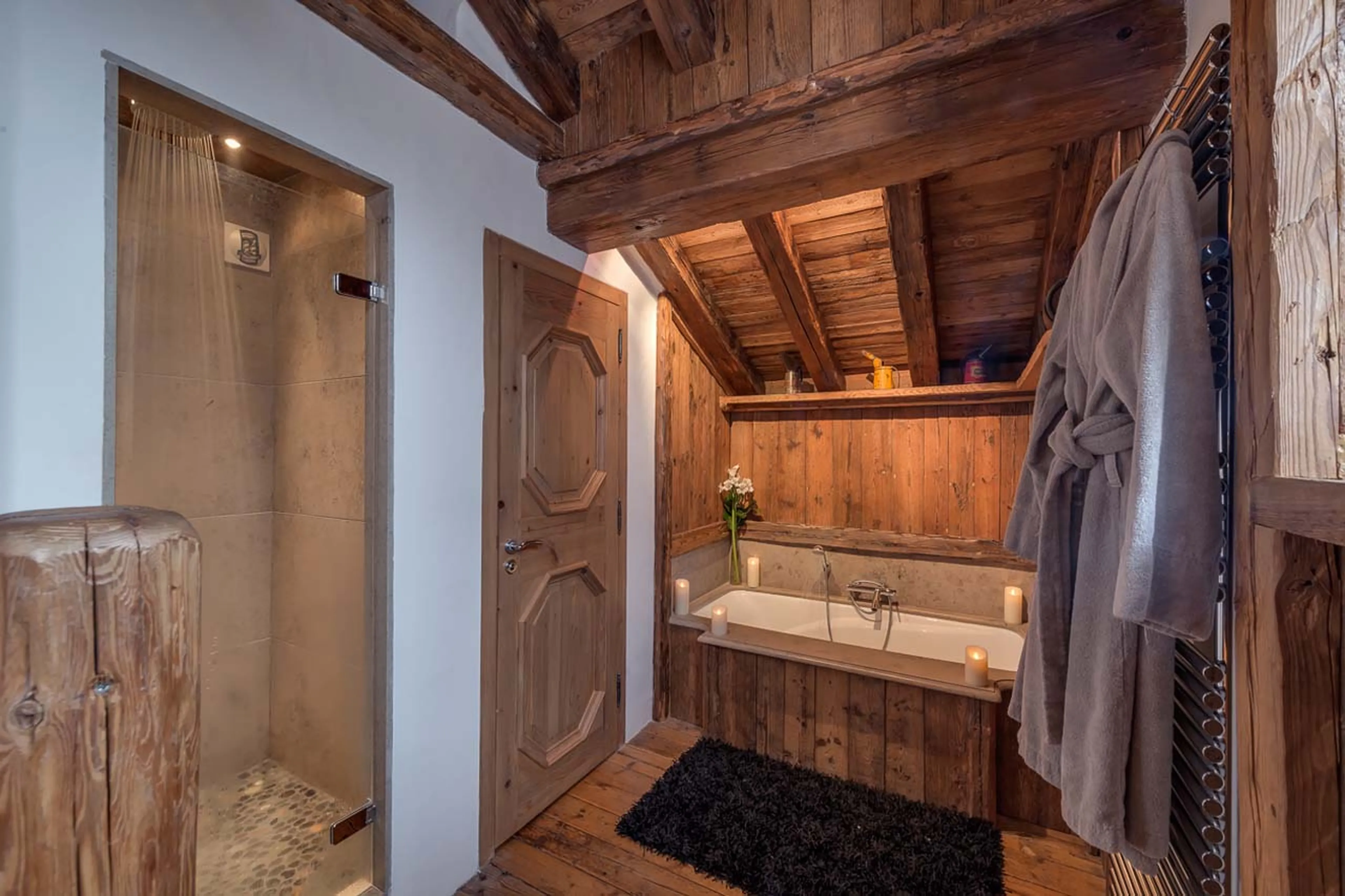En-suite master bathoom with bath, shower and dressing gowns in Chalet Le Rocher in Val d’Isere