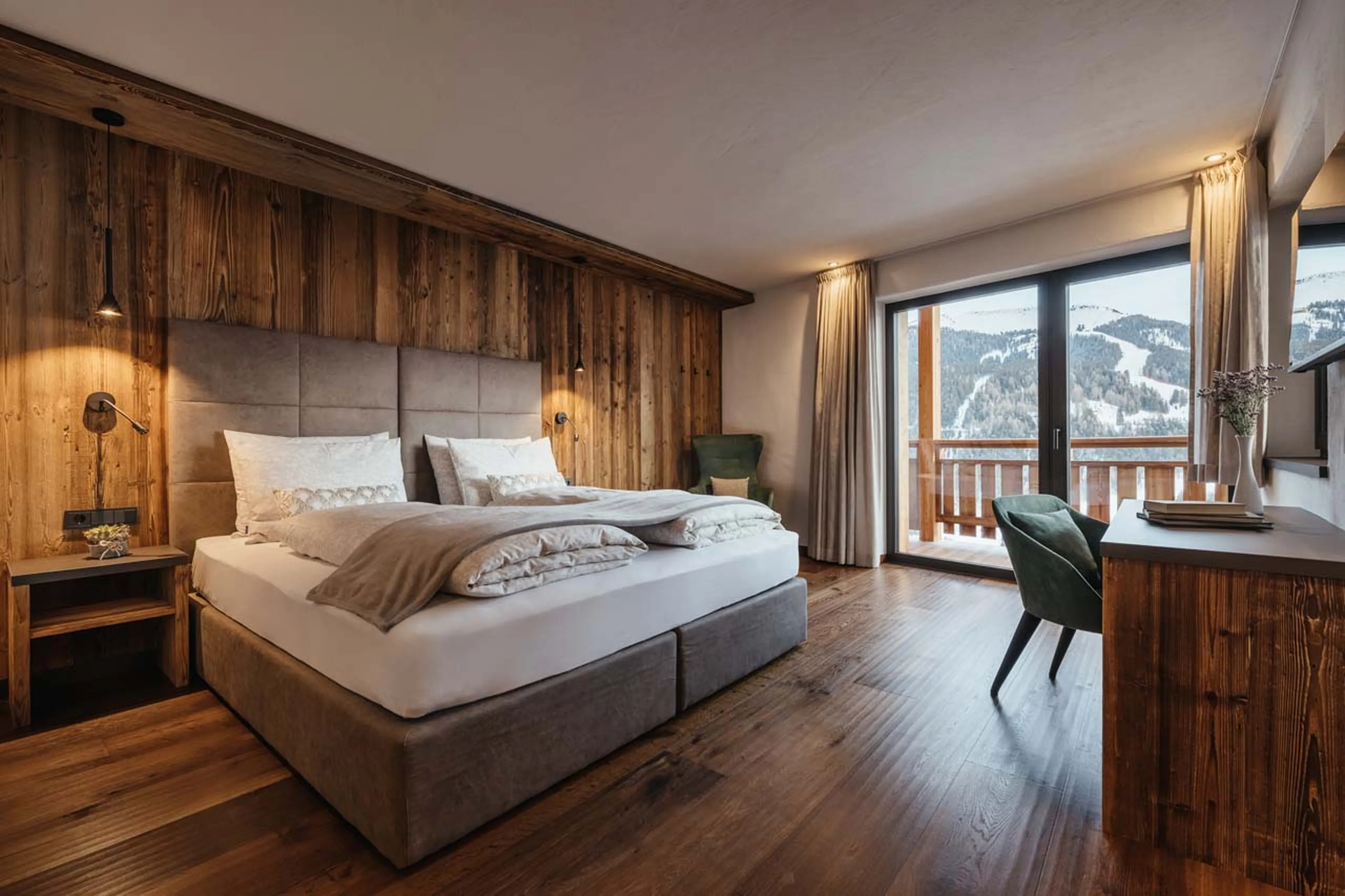 Double bedroom with desk and balcony access in Chalet Lefiro, Val Gardena