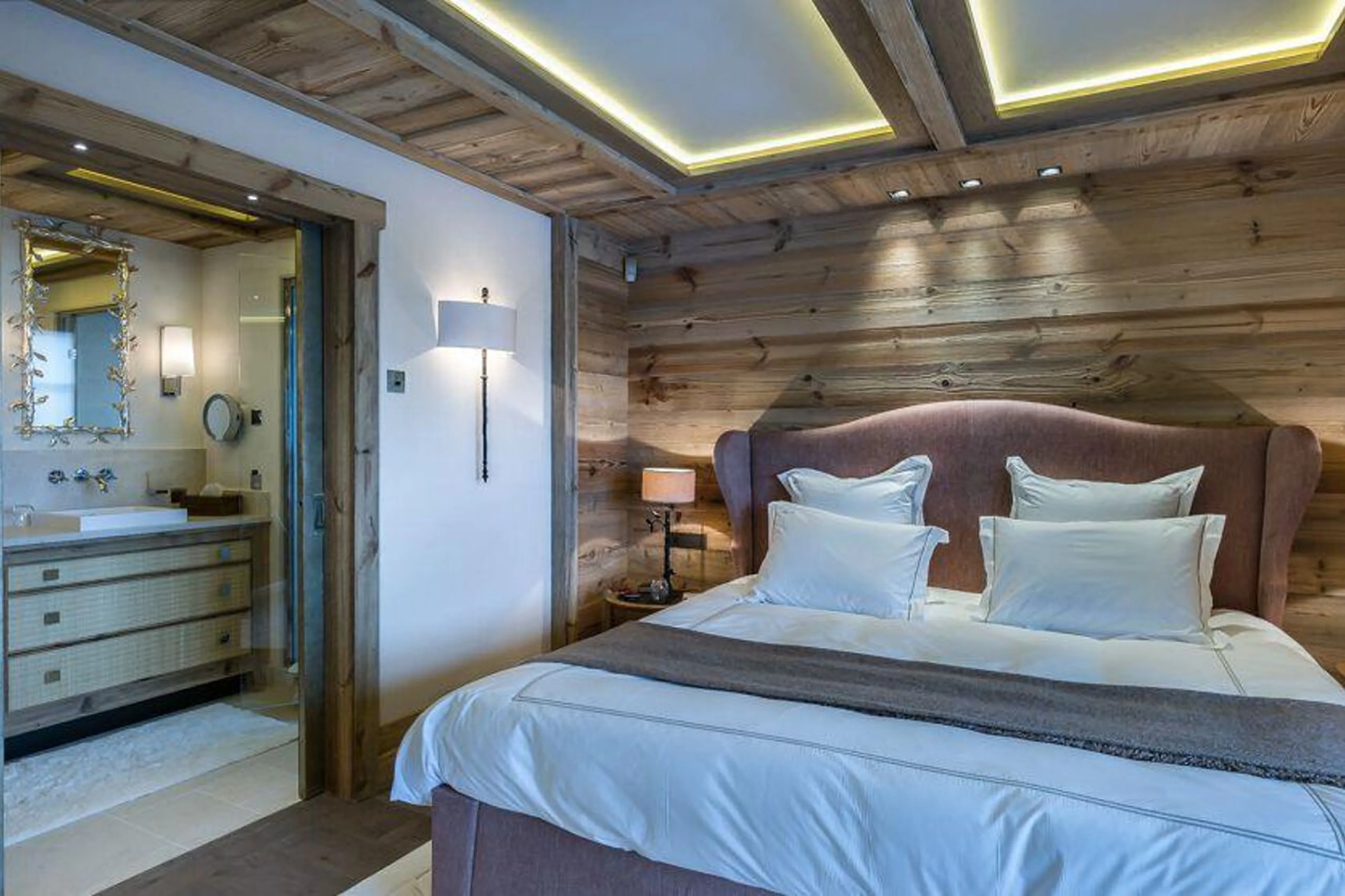 En suite master bedroom with king-size bed in Chalet Les Bastidons  in Courchevel 1850