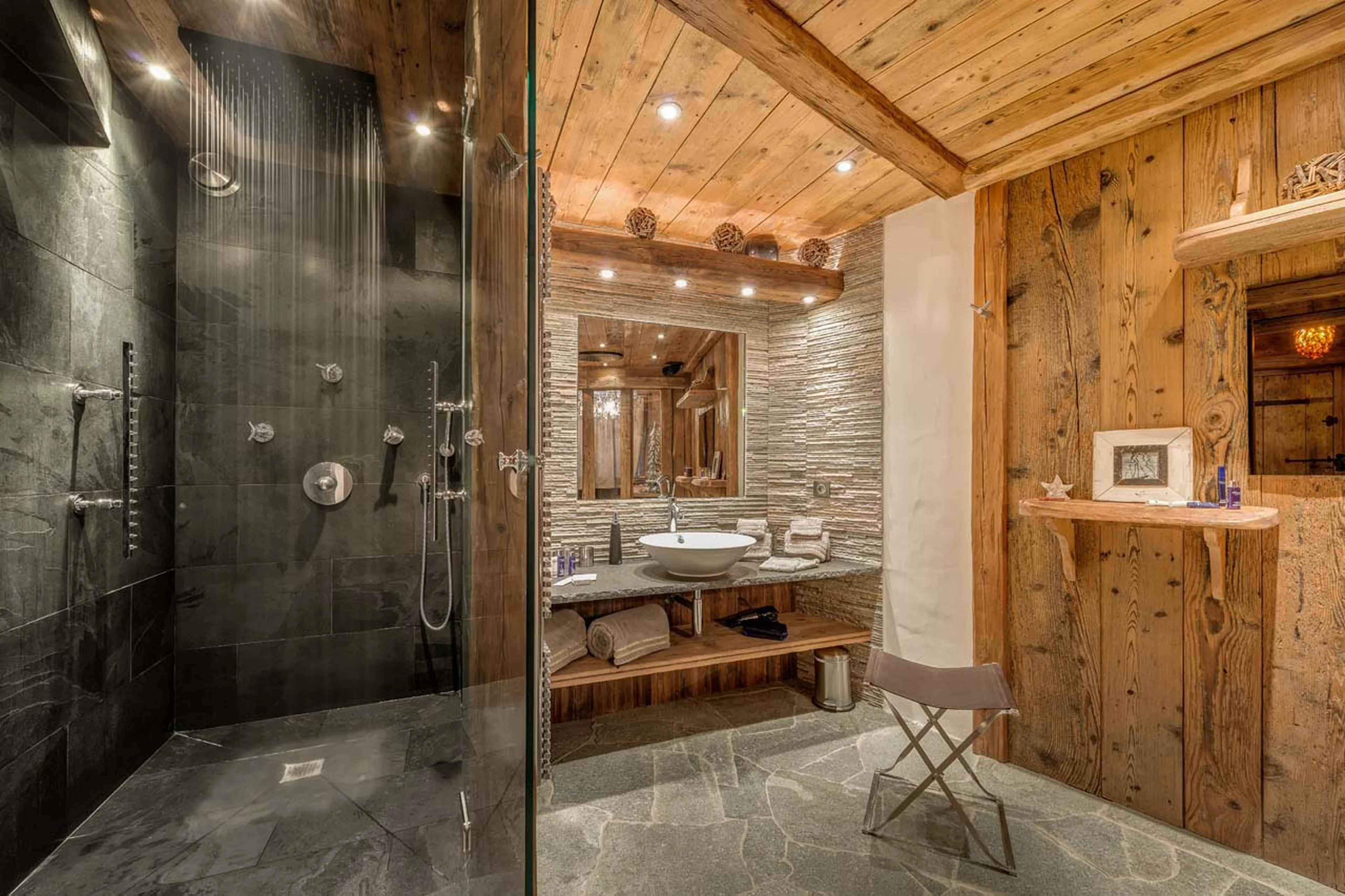En suite bathroom with granite bath tub and rain shower in Chalet Lhotse in Val d’ Isere