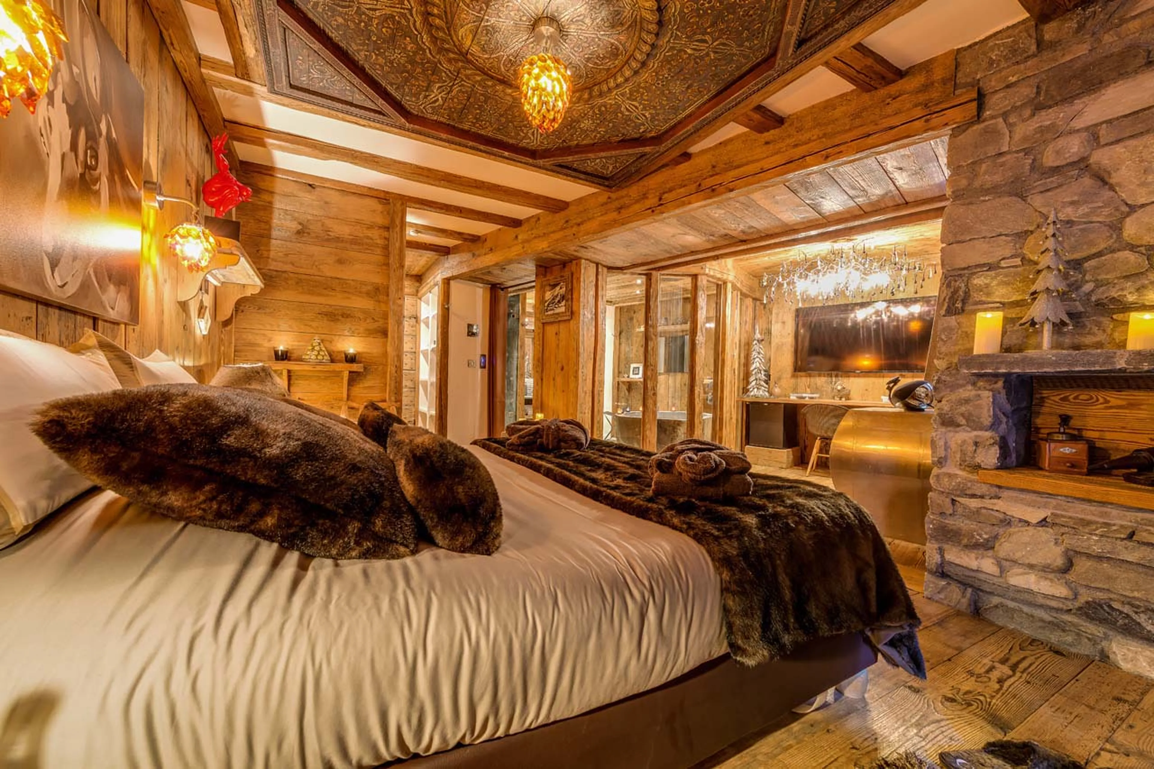 Master bedroom suite with king size bed, seating and dressing area in Chalet Lhotse in Val d’ Isere