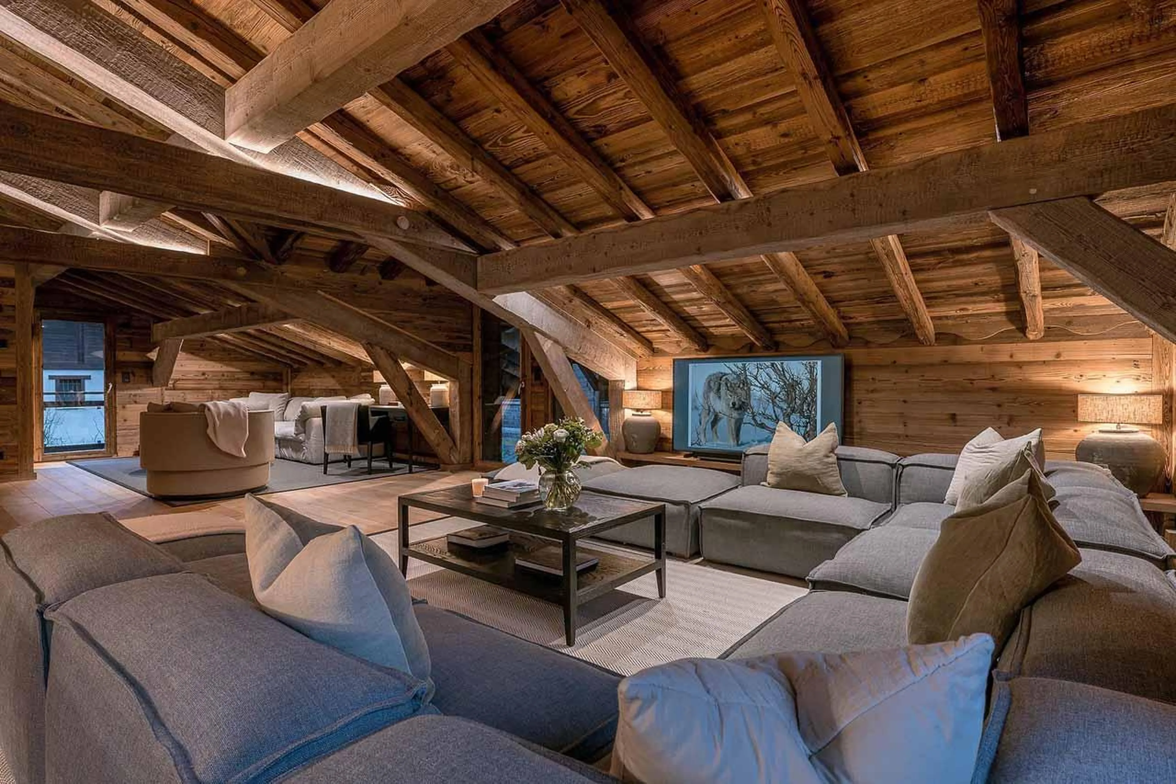 Wrap-around sofa facing TV in Chalet Lupa, Chamonix